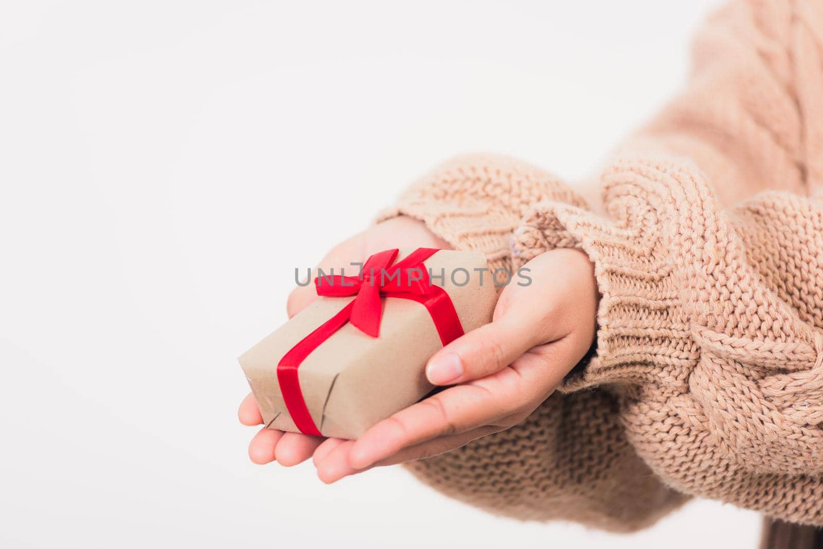 Valentine's Day. Woman beauty hands holding small gift package box present wrapped paper with ribbon isolated on white background, Birthday, New year, Christmas, holiday background concept