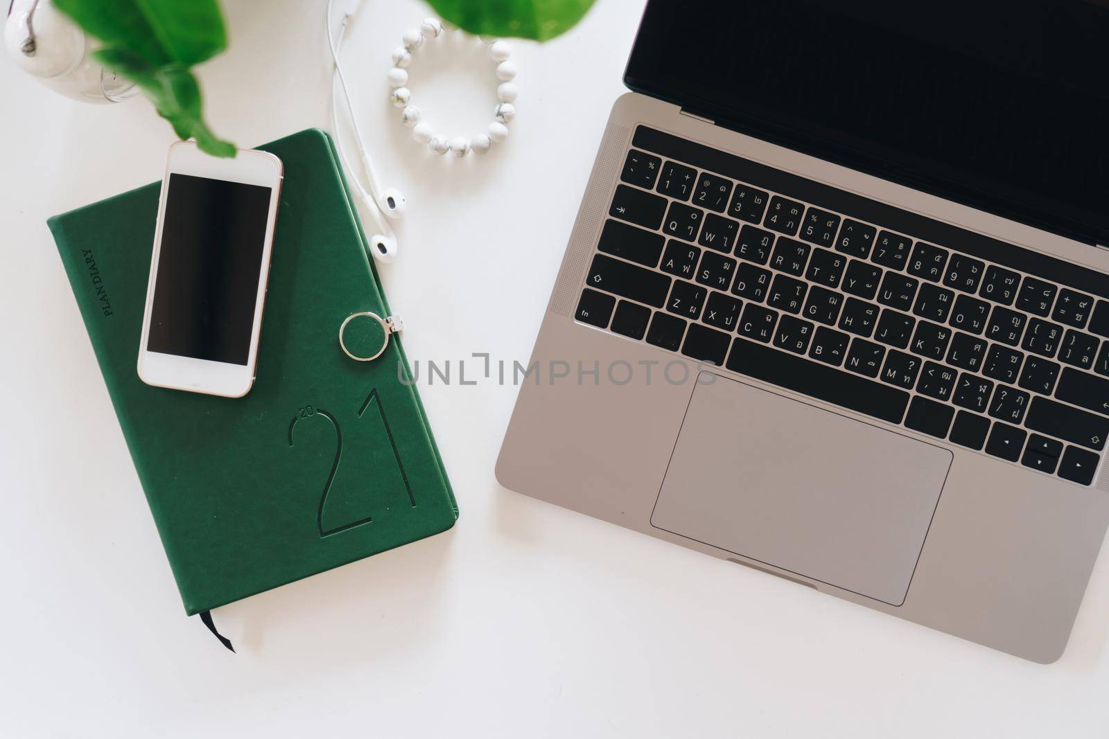 Top view of modern laptop or notebook with phone to work. Office desktop on table background.