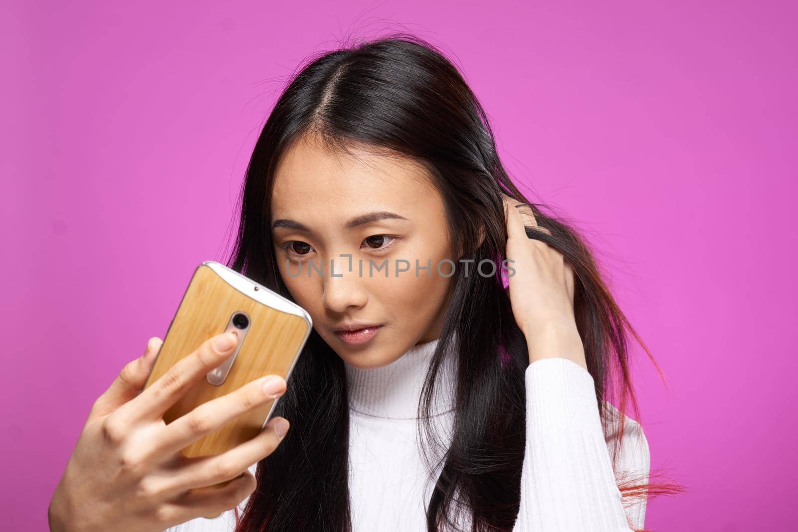 pretty woman with a phone in her hands looking at the screen internet communication technology. High quality photo