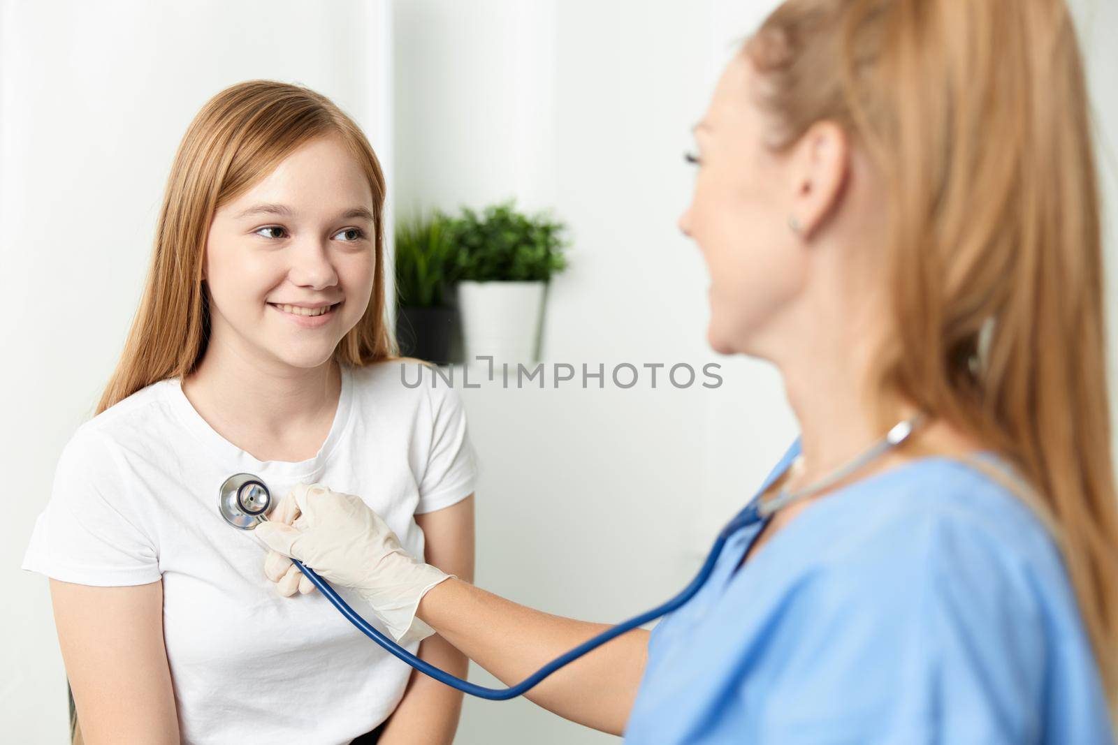 woman doctor examining a child stethoscope hospital. High quality photo