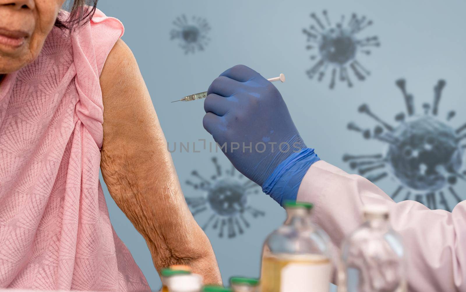 Doctor doing vaccine injection to senior woman.