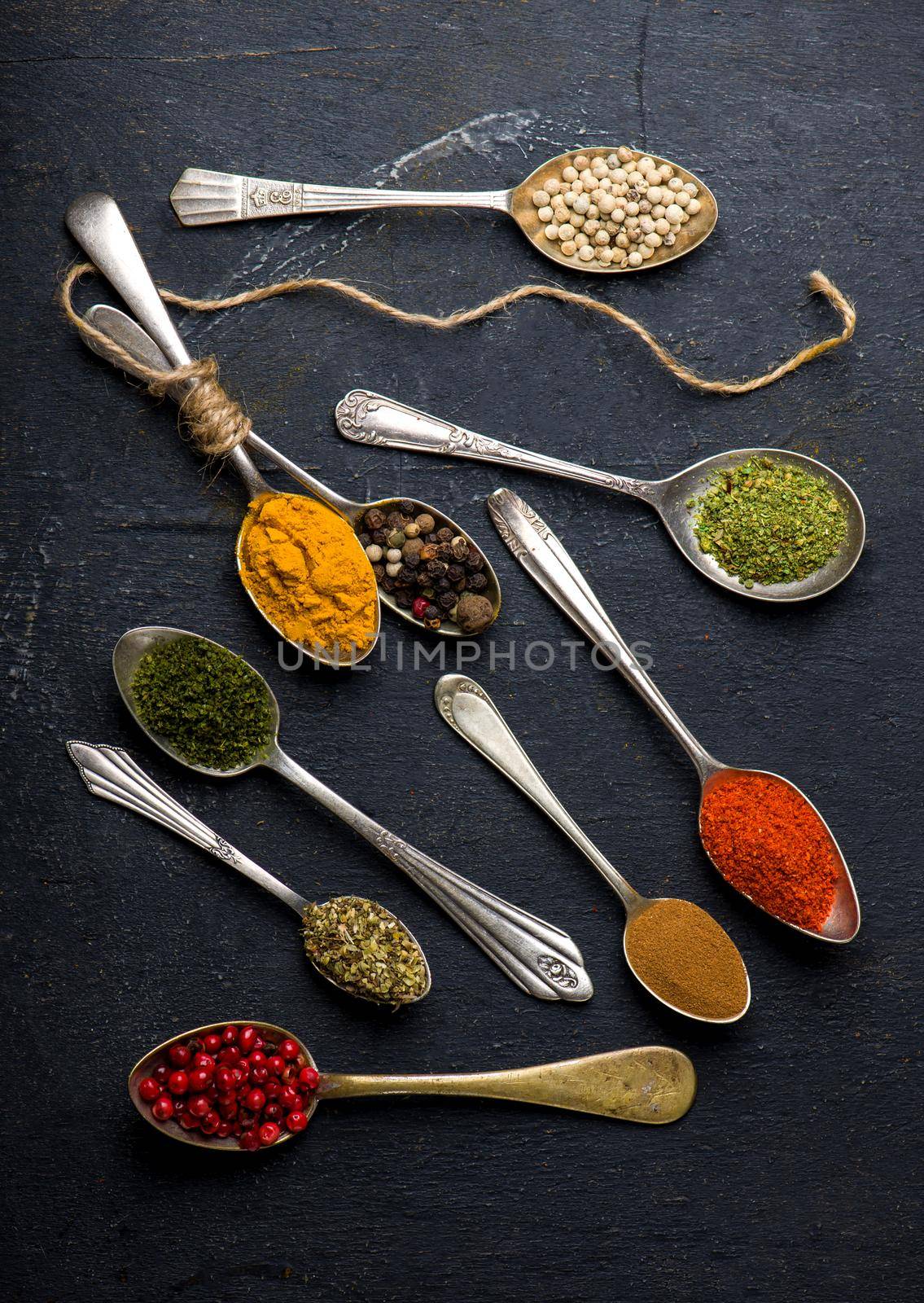 Various spices spoons on black table. Top view with copy space by aprilphoto