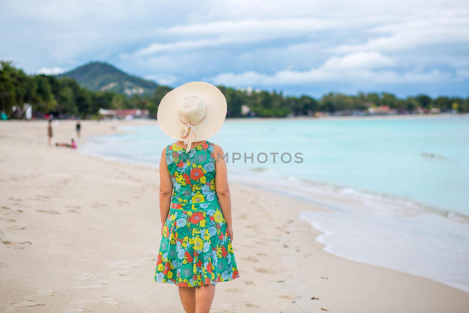 Asian middle aged woman relaxing at chaweng beach in koh samui ,Thailand. by toa55