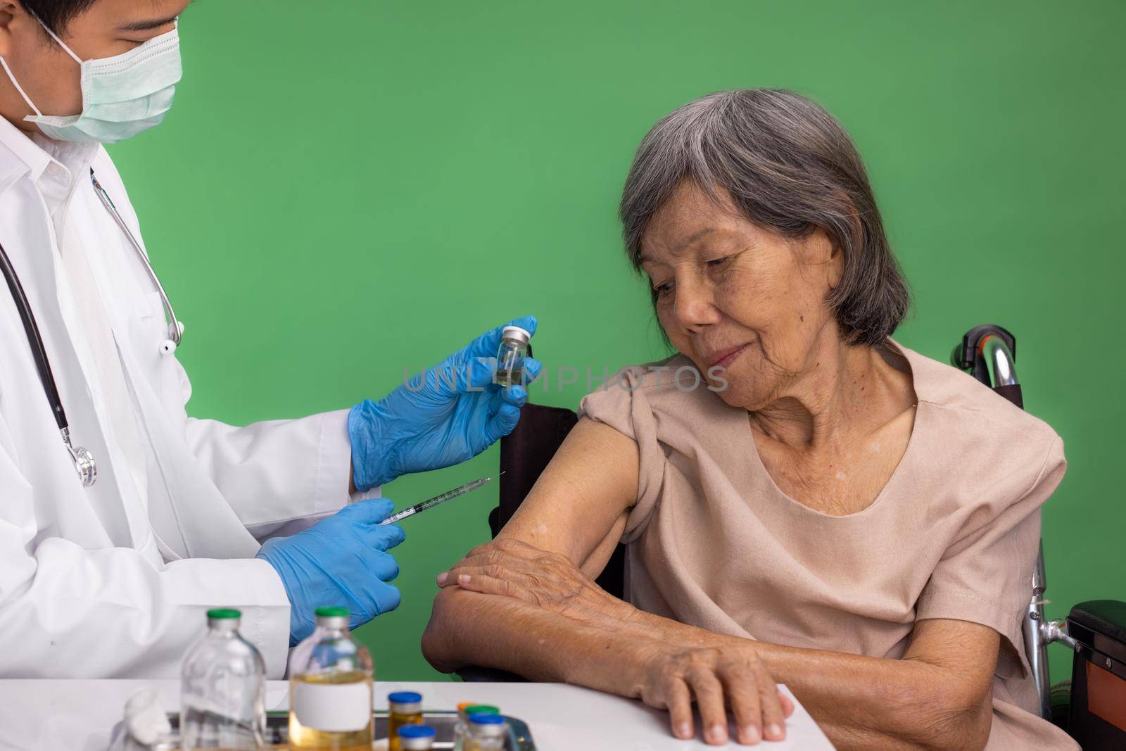 Chroma key, nurse doing vaccine injection to senior woman. by toa55