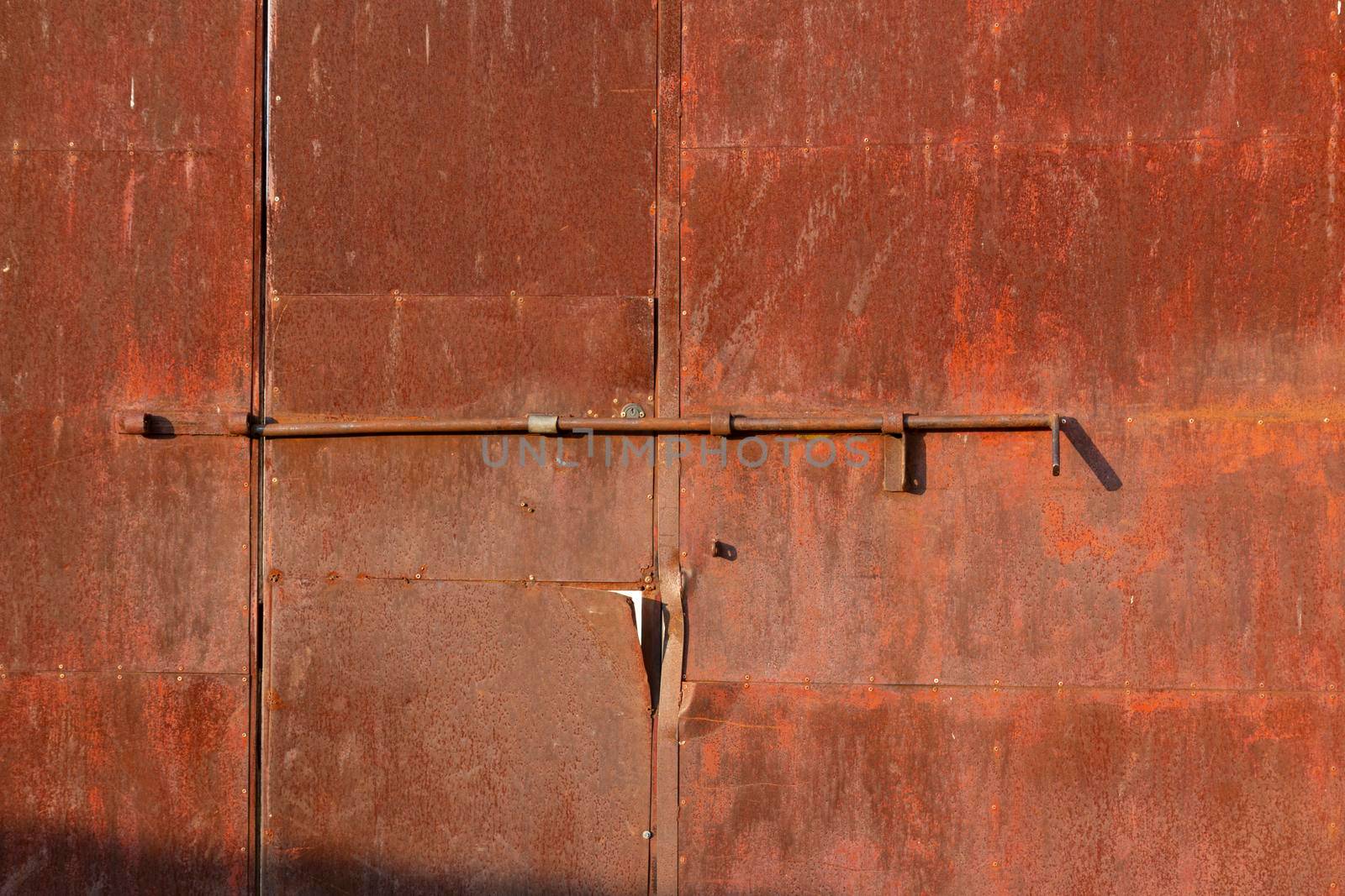 Old door of an abandoned factory in southern Spain by loopneo