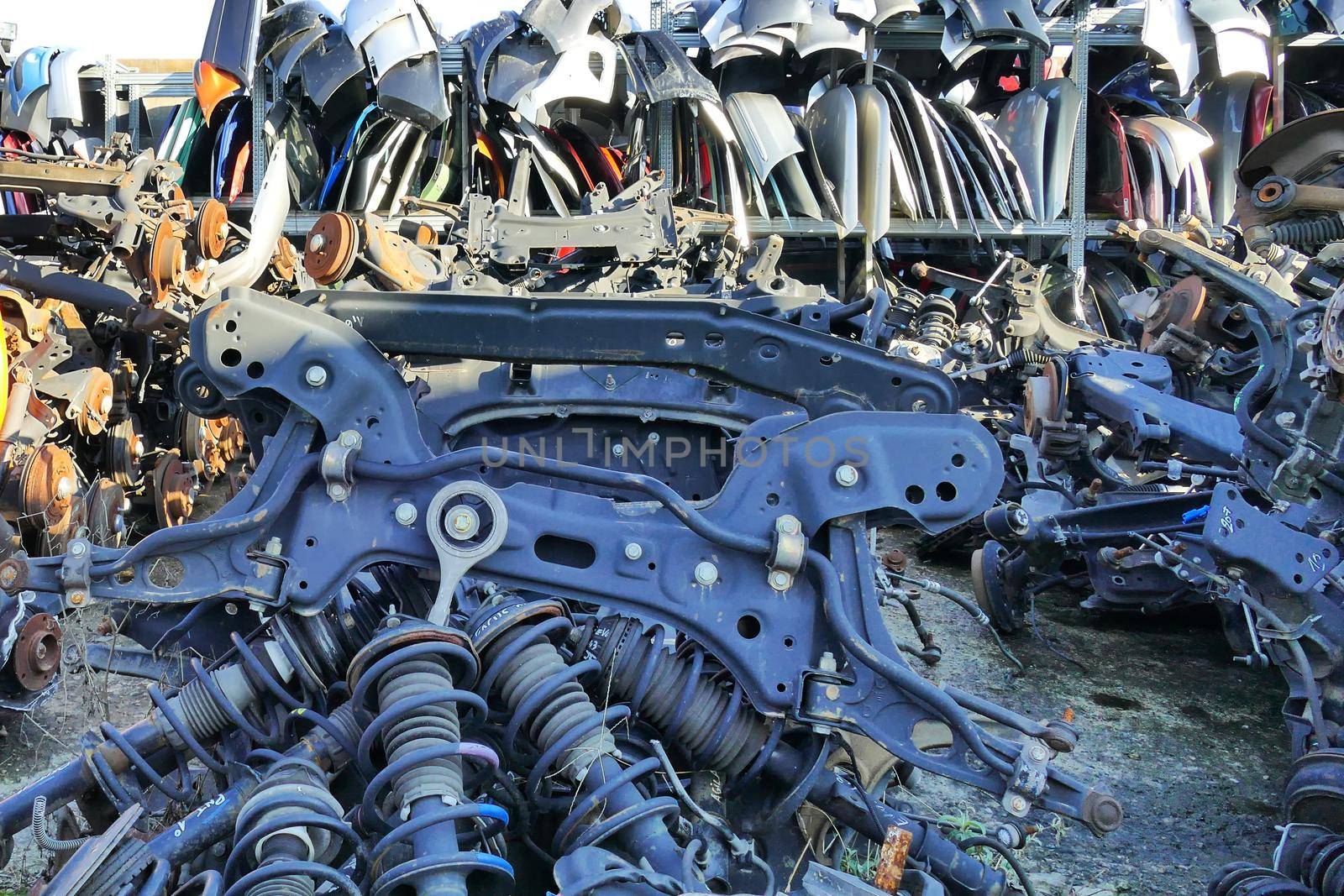 Disassembled polluting car parts accumulated for their reuse or disposal of metals and plastic by lemar