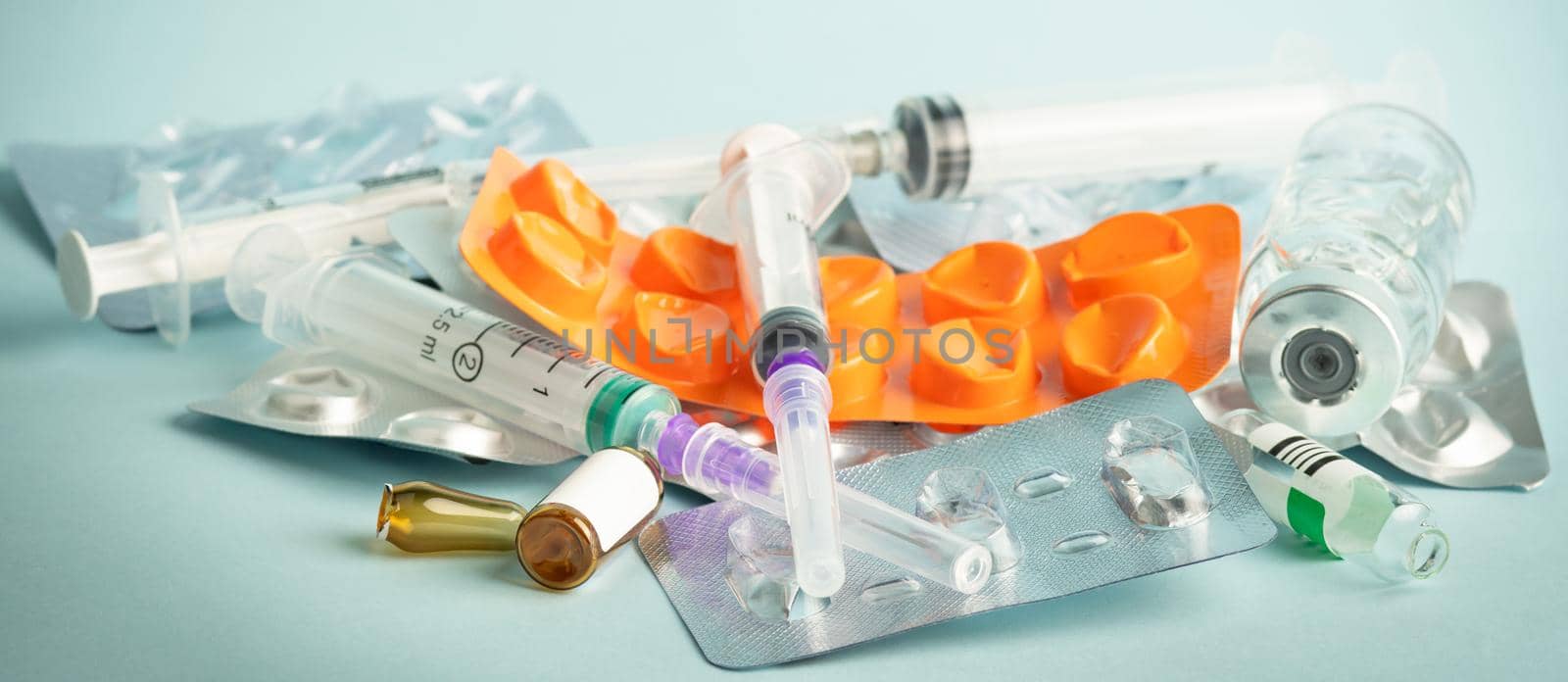Used syringes and empty medication containers. A large number of empty medicine containers.