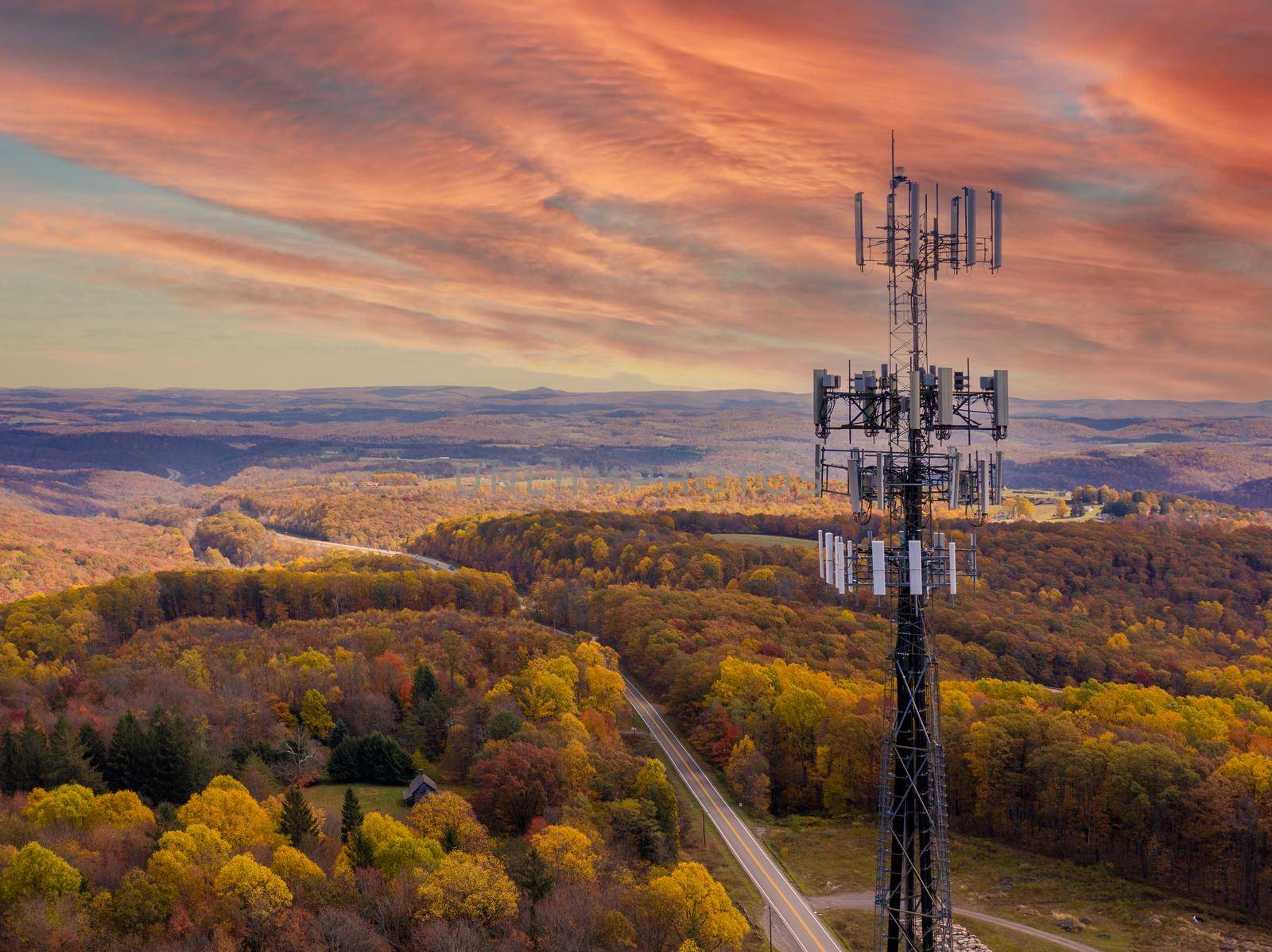 Aerial view of mobile phone cell tower over forested rural area of West Virginia to illustrate lack of broadband internet service