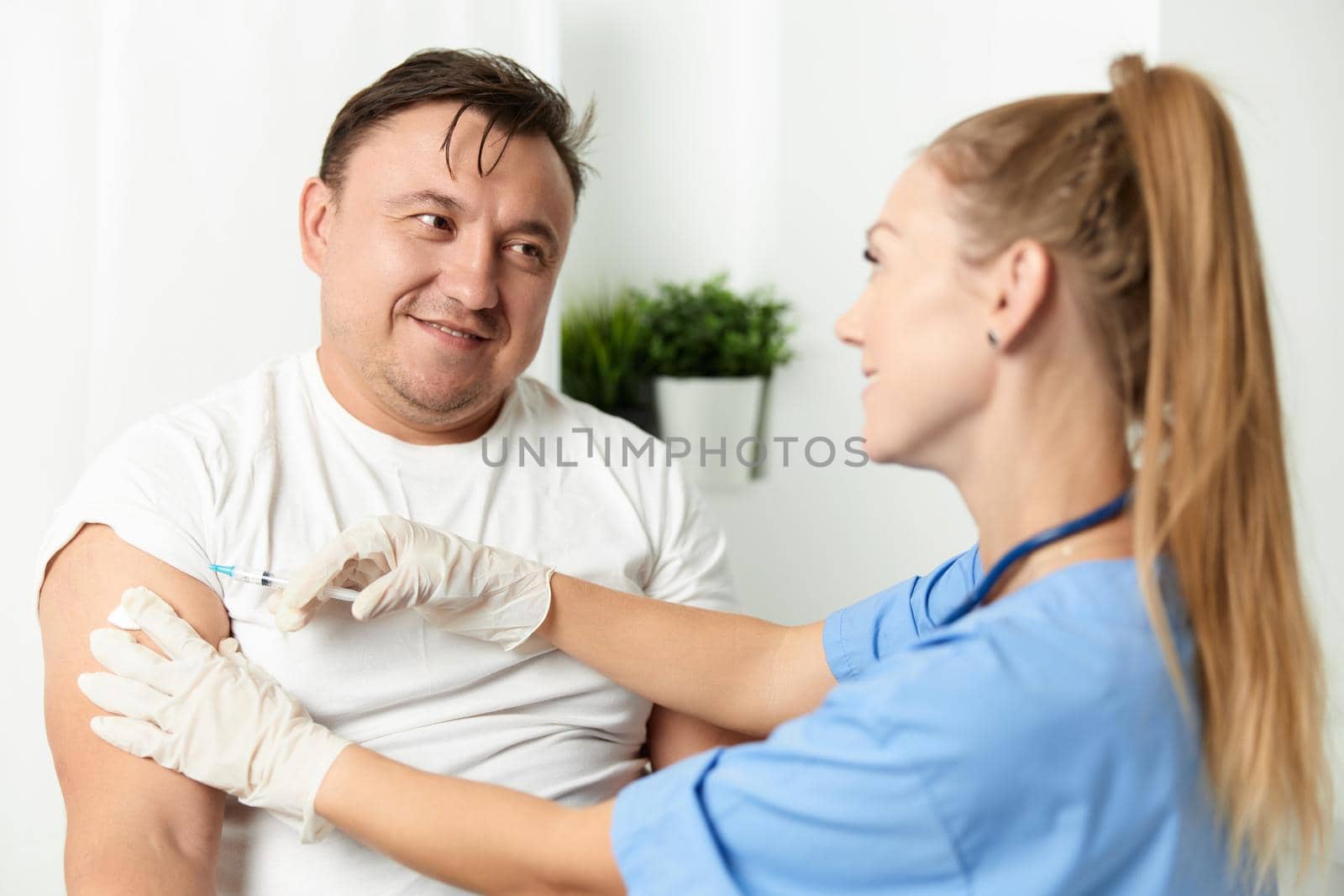 male patient in hospital next to doctor injection. High quality photo