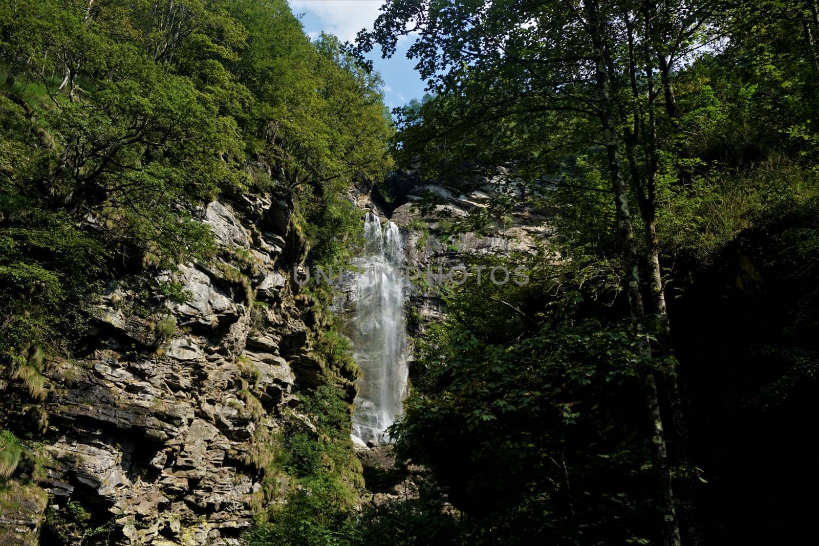 The Val Moett waterfall cascading down a massive rock in the Verzasca valley, Ticino, Switzerland