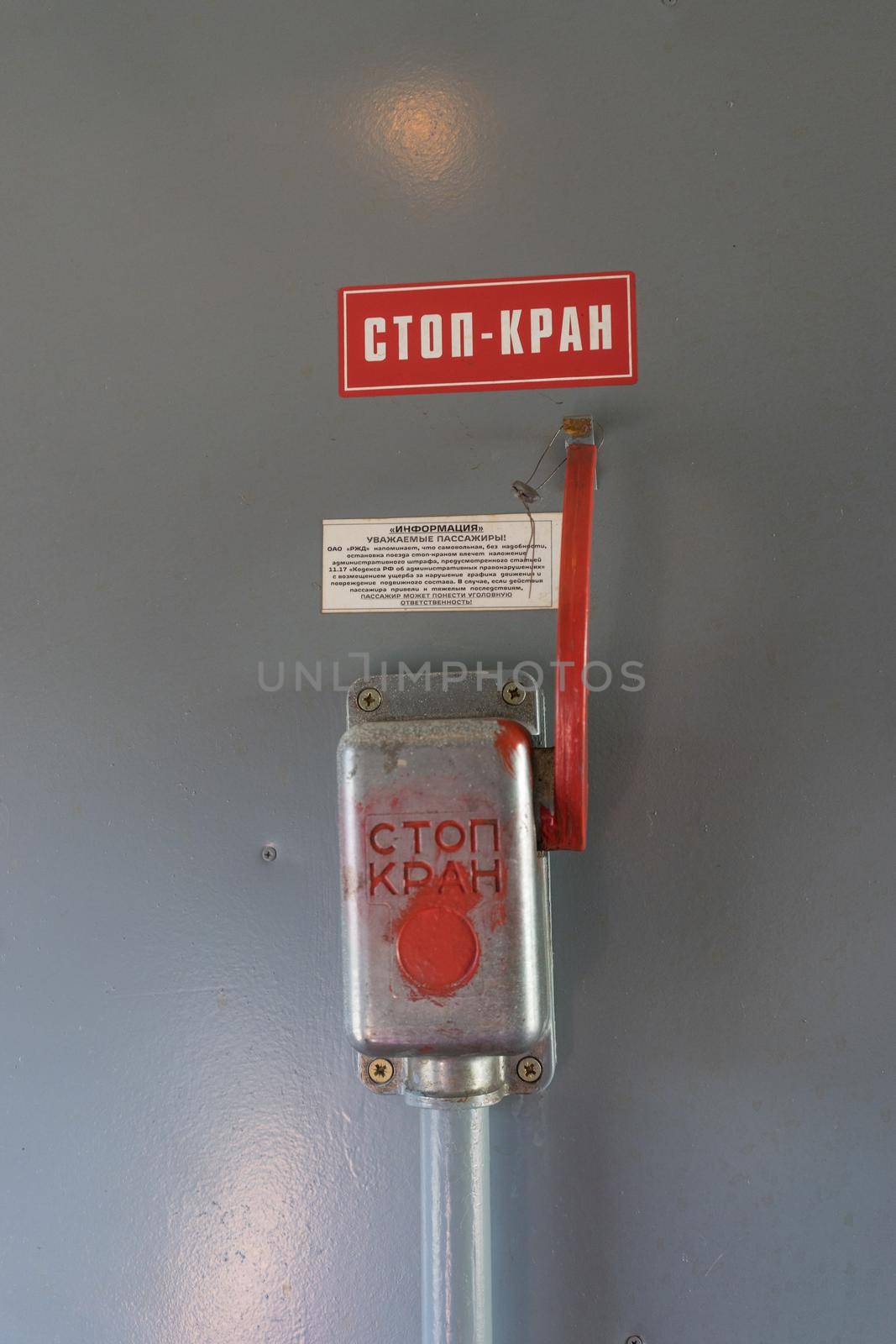 Closeup of emergency brake lever on brown wall in train