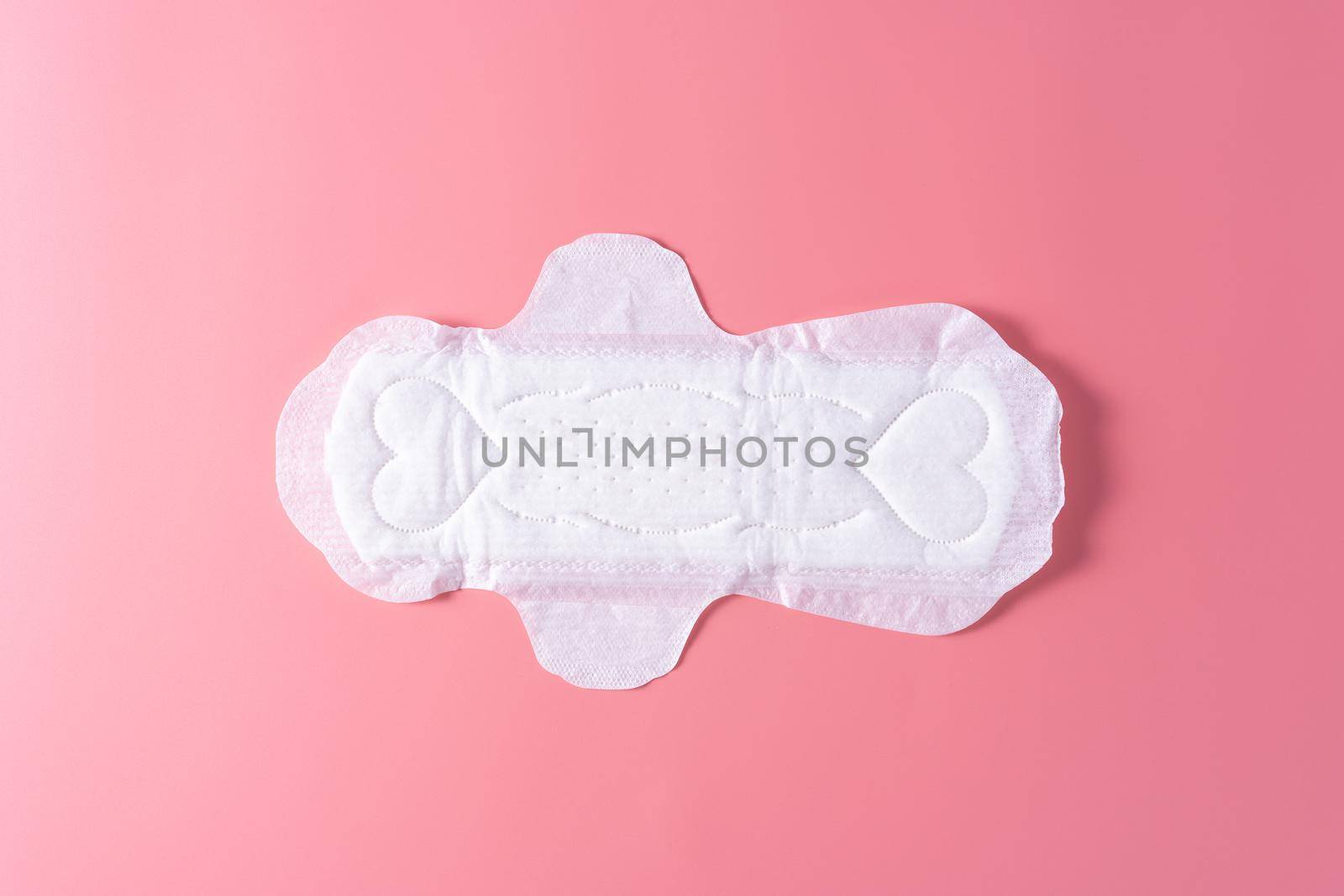 Sanitary pad, Sanitary napkin on pink background. Menstruation, Feminine hygiene, top view.