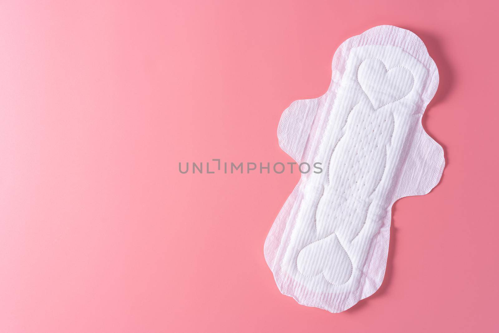 Sanitary pad, Sanitary napkin on pink background. Menstruation, Feminine hygiene, top view. by mikesaran