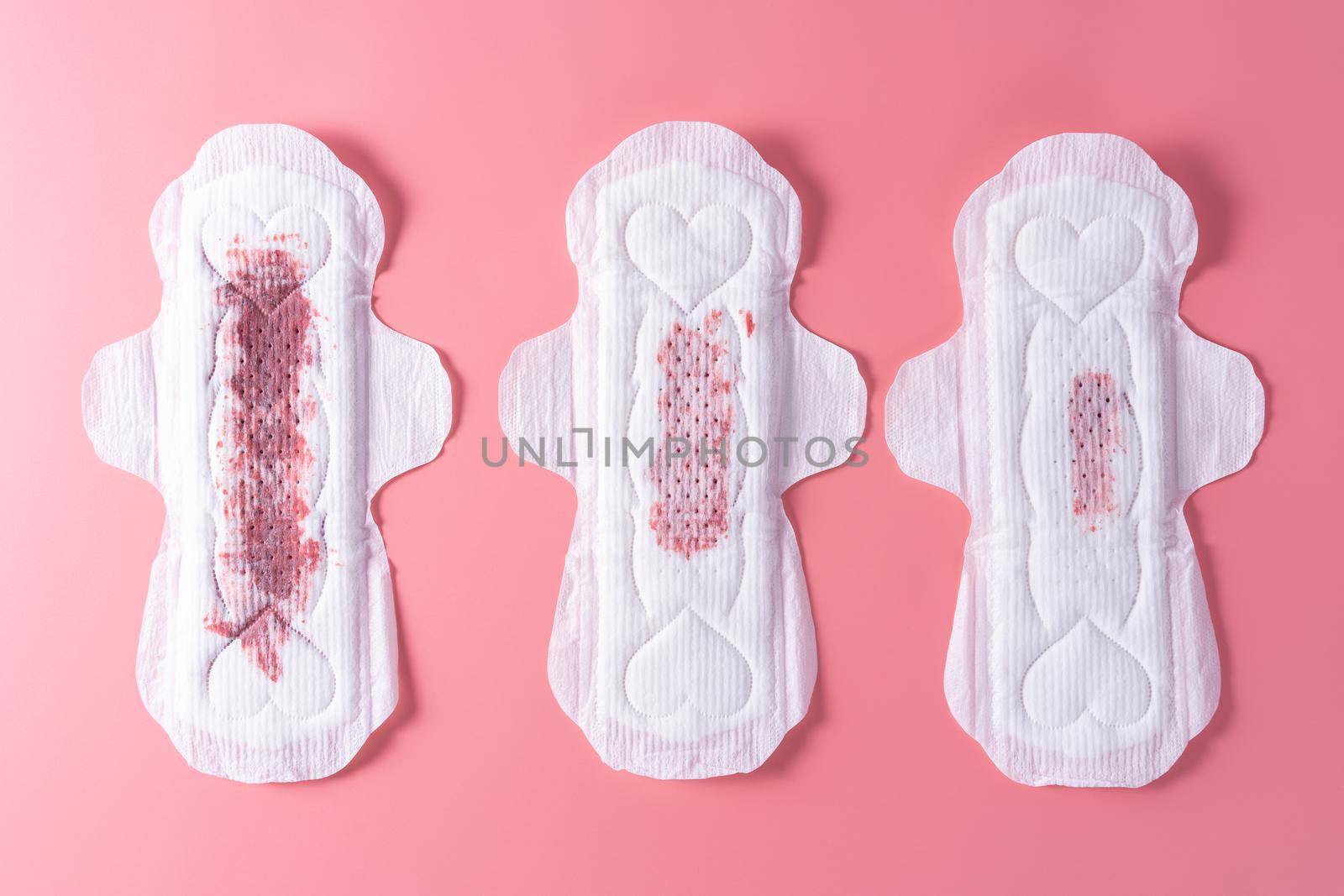 Set of different used sanitary pad, Sanitary napkin on pink background. Menstruation, Feminine hygiene, top view. by mikesaran