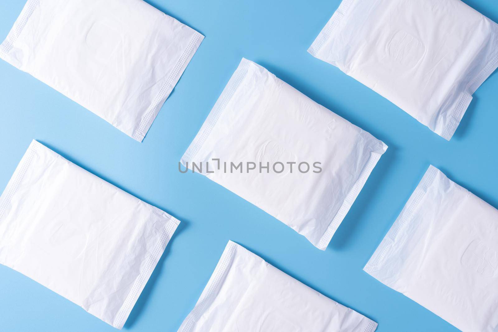 Pattern of Sanitary pad, Sanitary napkin on blue background. Menstruation, Feminine hygiene, top view.