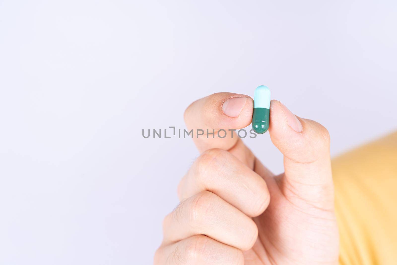 Close up hands holding pill drugs. Healthcare and medical pharmacy concept. by mikesaran