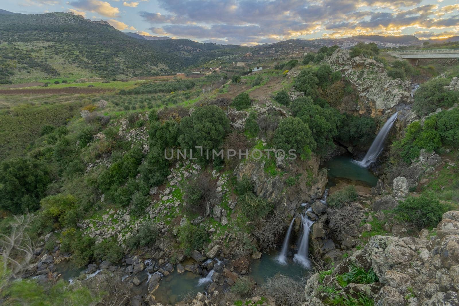 Sunrise view of the Saar waterfall, with the Nimrod fortress in the background. The Golan Heights, Northern Israel
