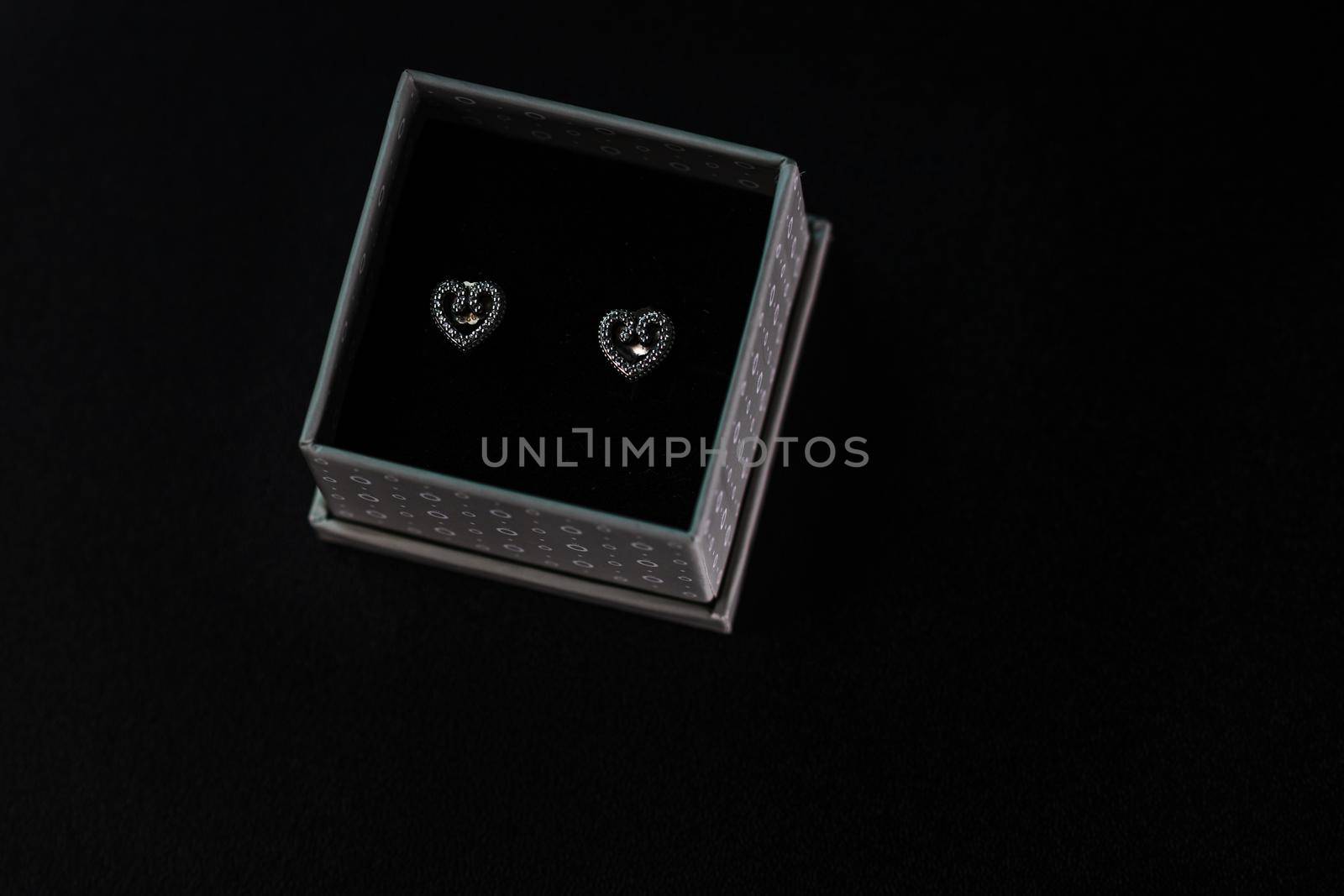 Beautiful silver earrings isolated on black, close up