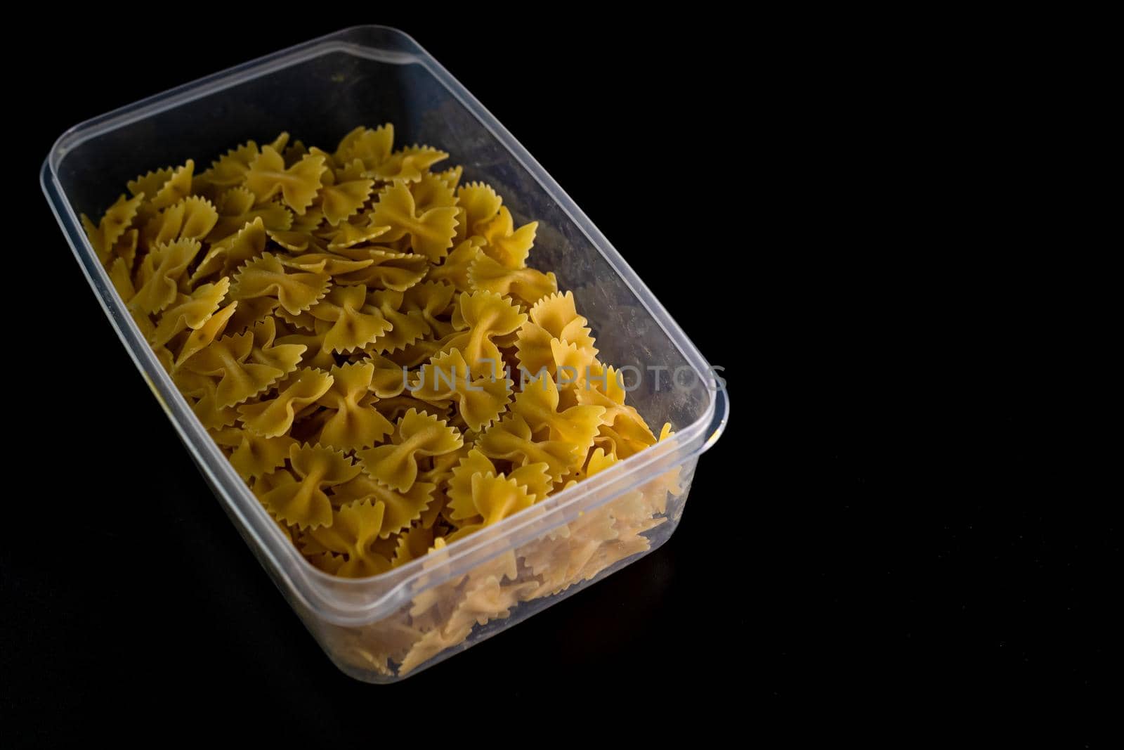 Close up of dry uncooked farfalle pasta isolated.