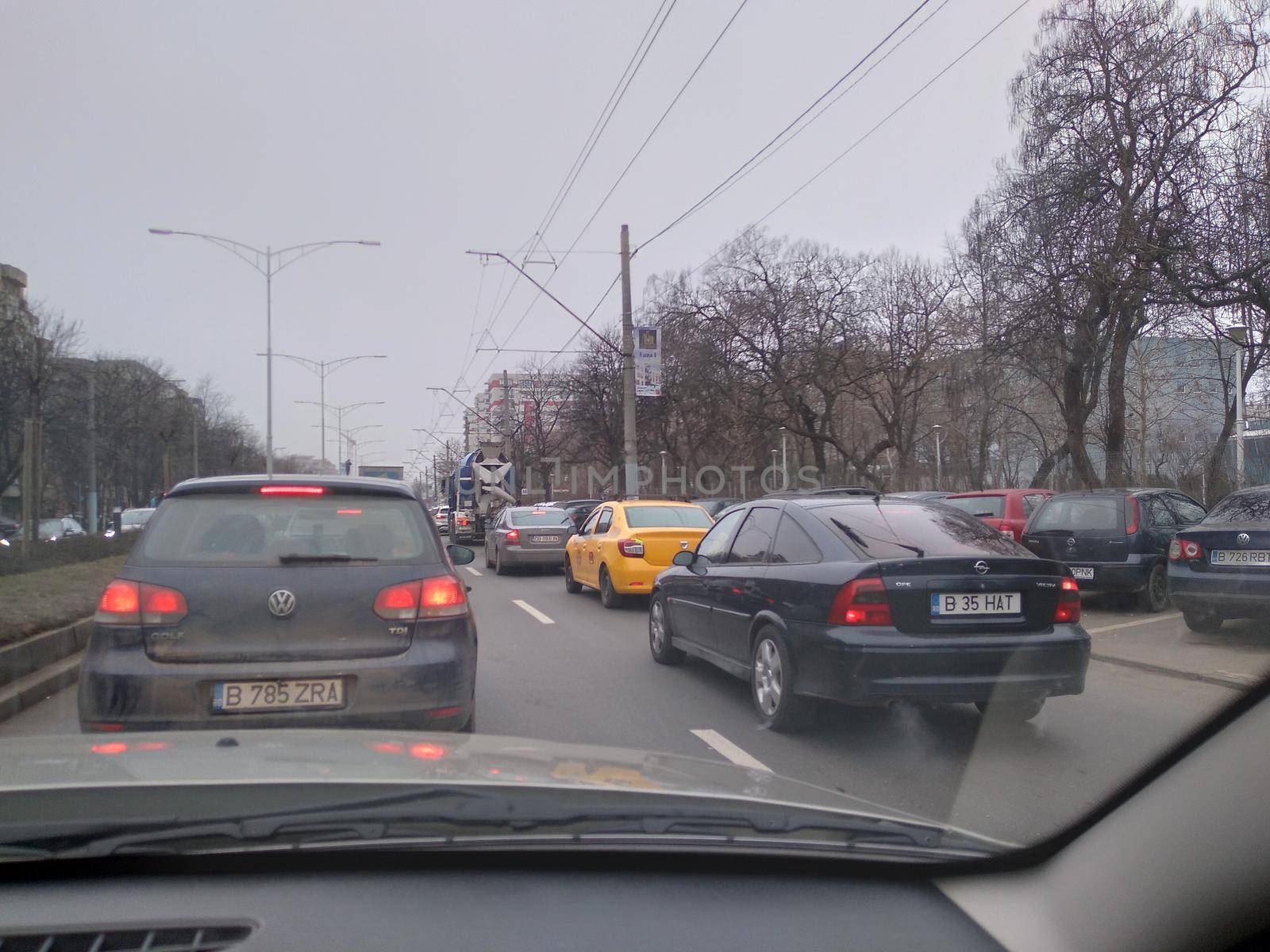 Road view through car windshield, cars on road in traffic in Bucharest, Romania, 2021 by vladispas