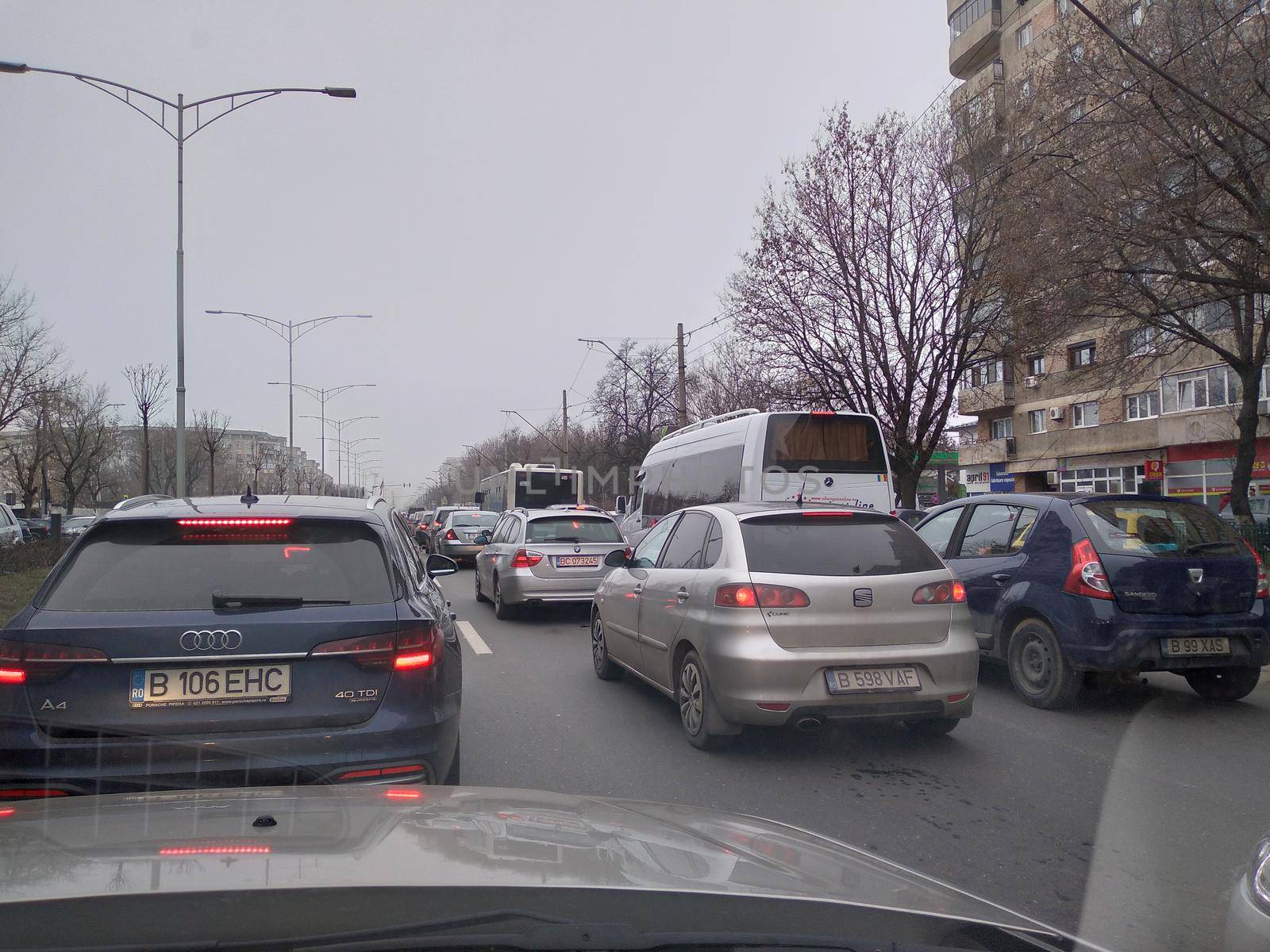 Road view through car windshield, cars on road in traffic in Bucharest, Romania, 2021
