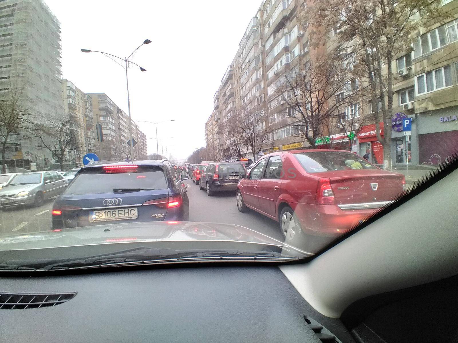 Road view through car windshield, cars on road in traffic in Bucharest, Romania, 2021 by vladispas