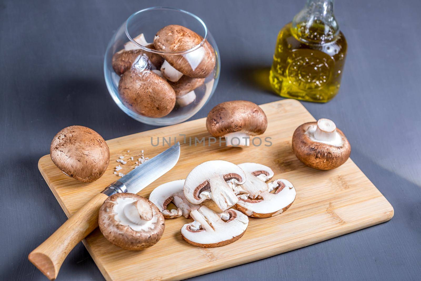 Parisian champignons, chopped mushrooms on wooden chopping board by galinasharapova