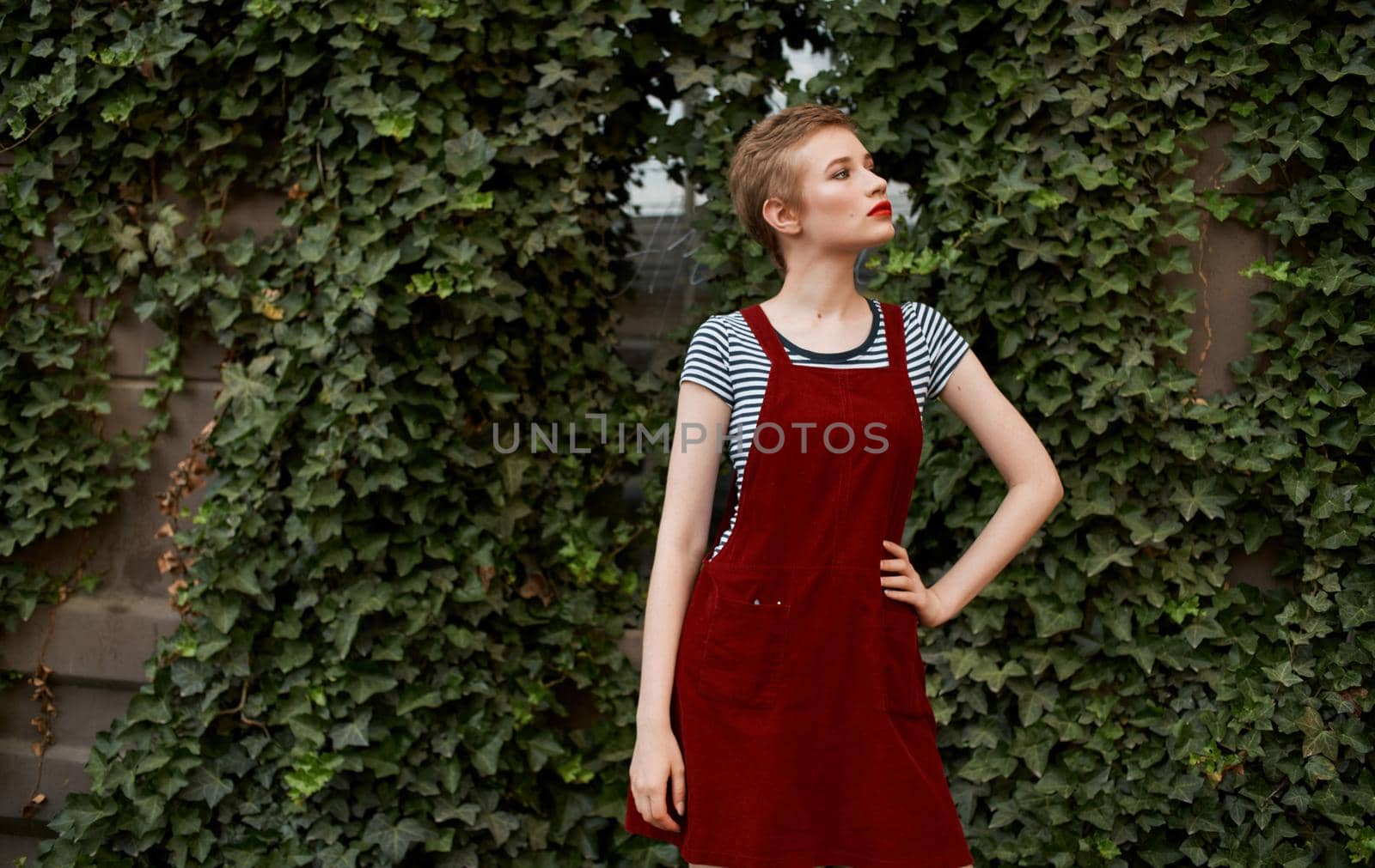 cute blonde short hair walk in the park Red sundress. High quality photo