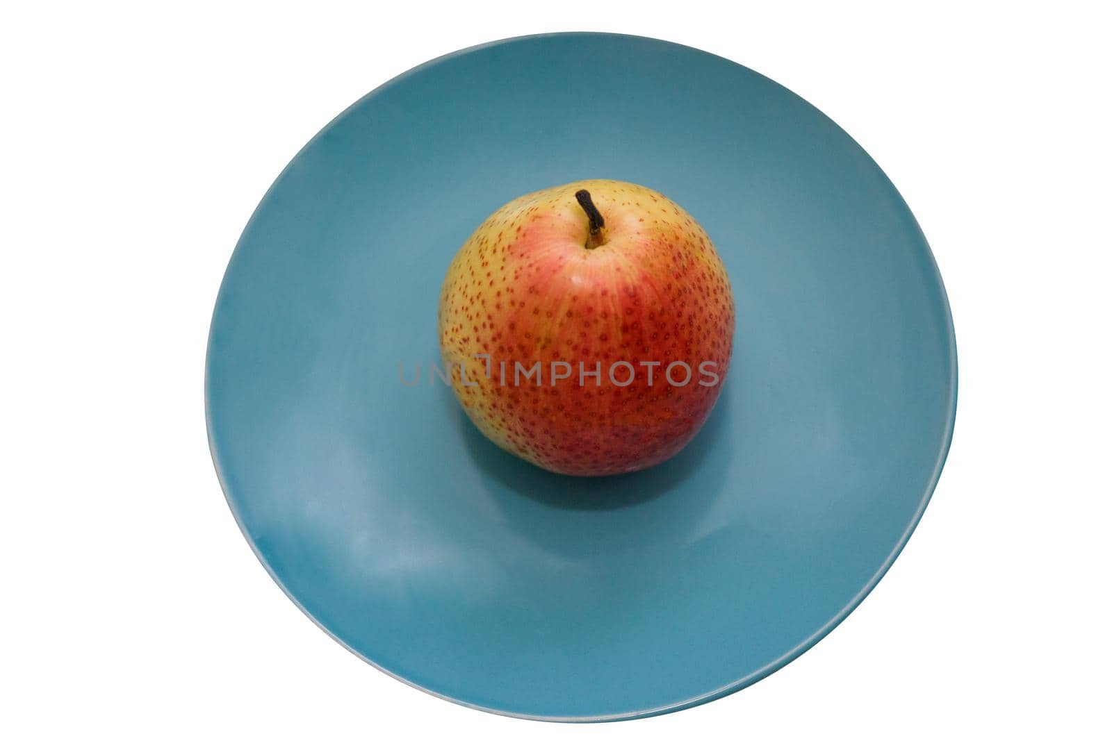 Juicy pear on a blue ceramic plate isolate on white background