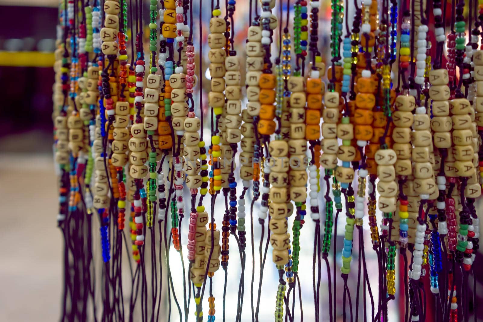 Bracelets with beads and letters on the shop window.