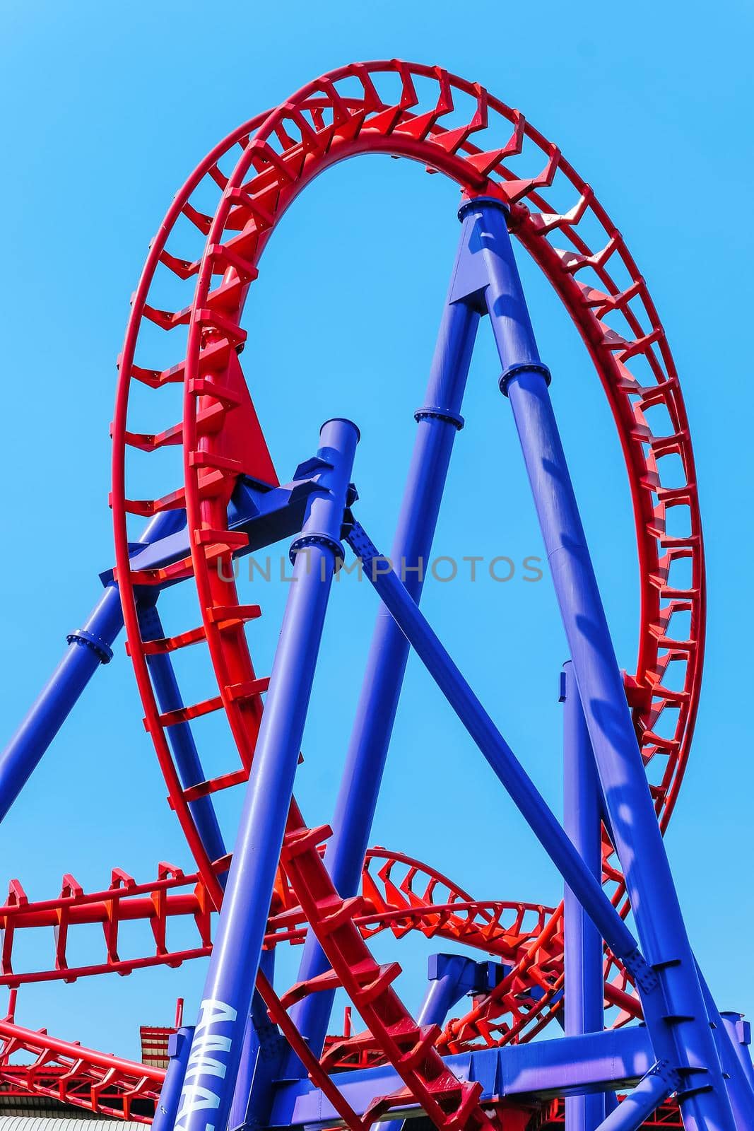 close-up image of a rollercoaster track and the blue sky