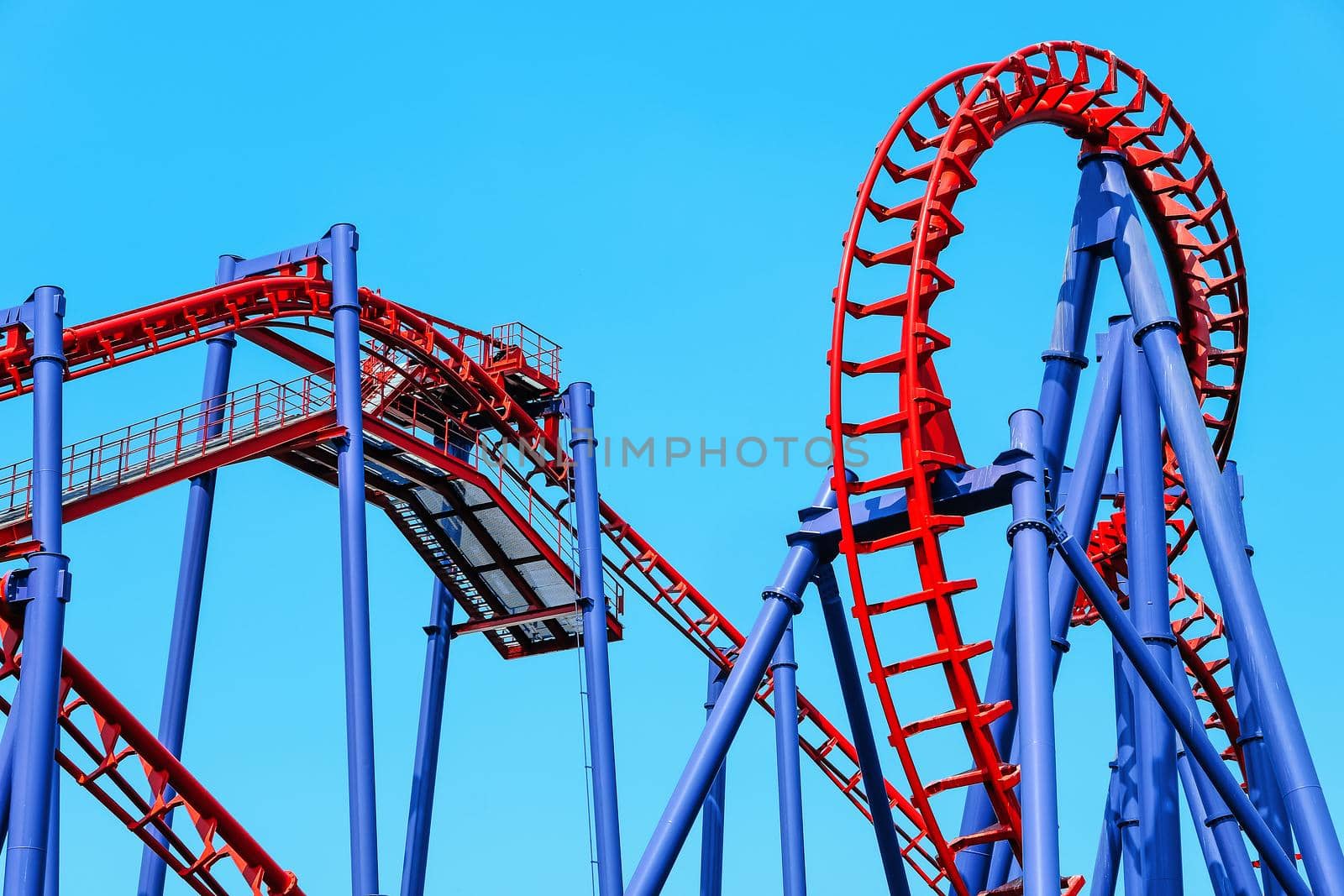 close-up image of a rollercoaster track and the blue sky