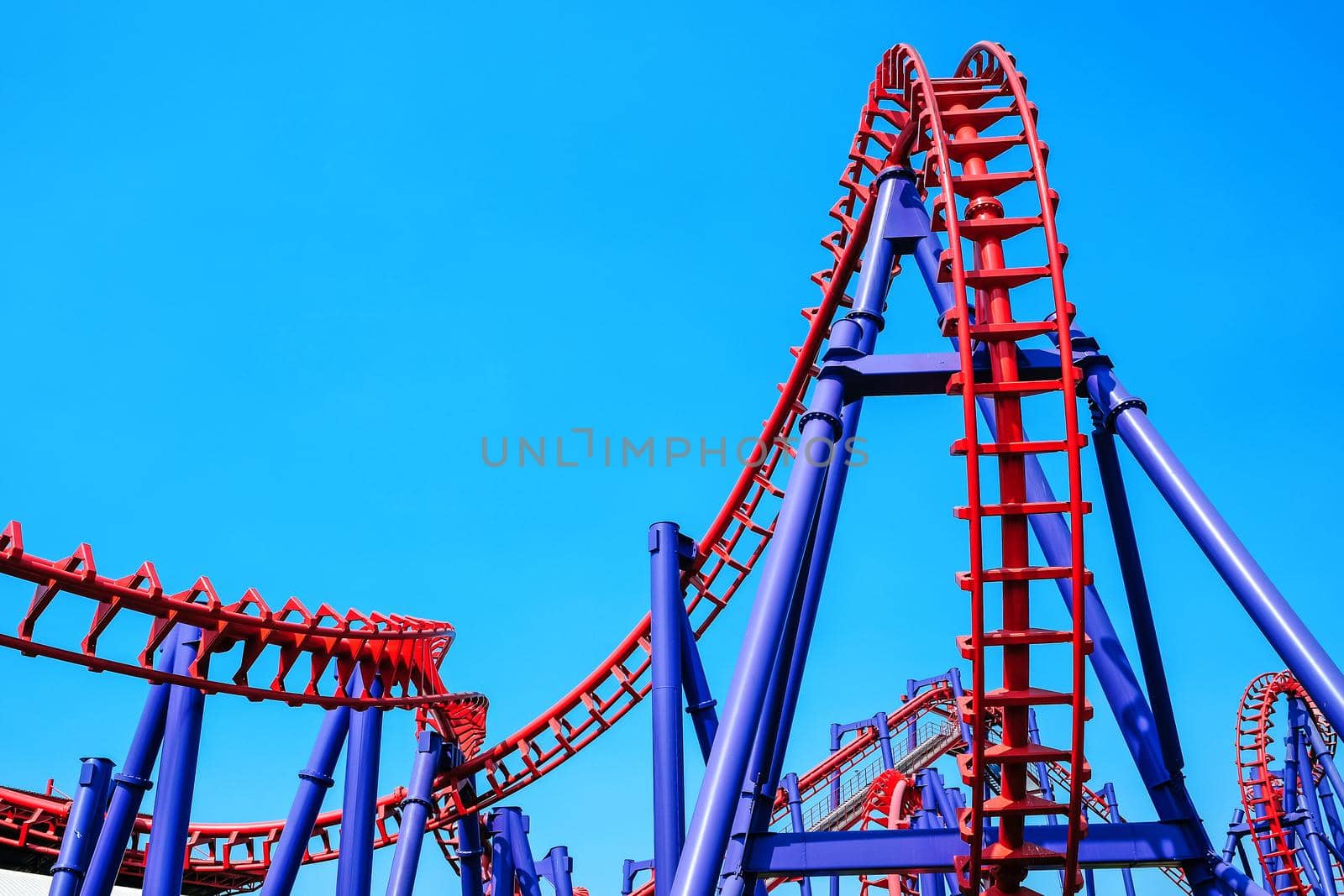 close-up image of a rollercoaster track and the blue sky
