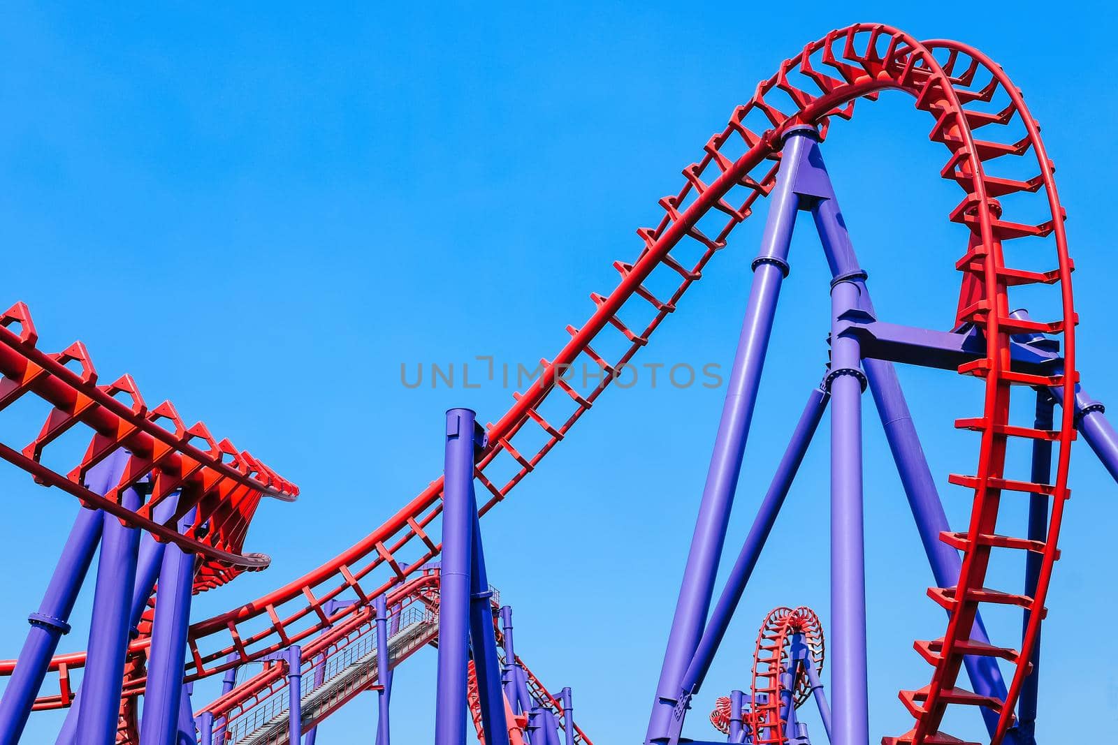 close-up image of a rollercoaster track and the blue sky