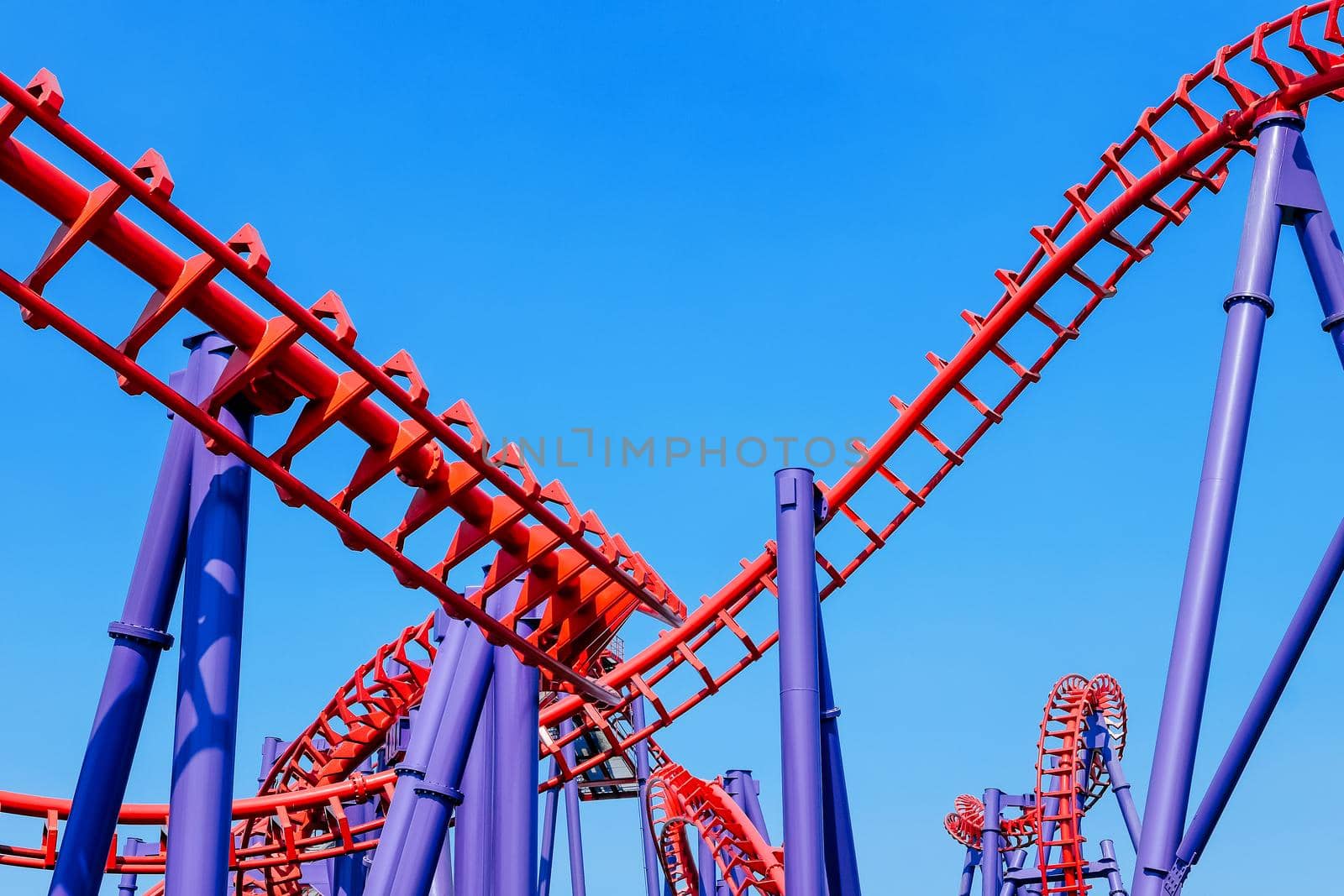 close-up image of a rollercoaster track and the blue sky