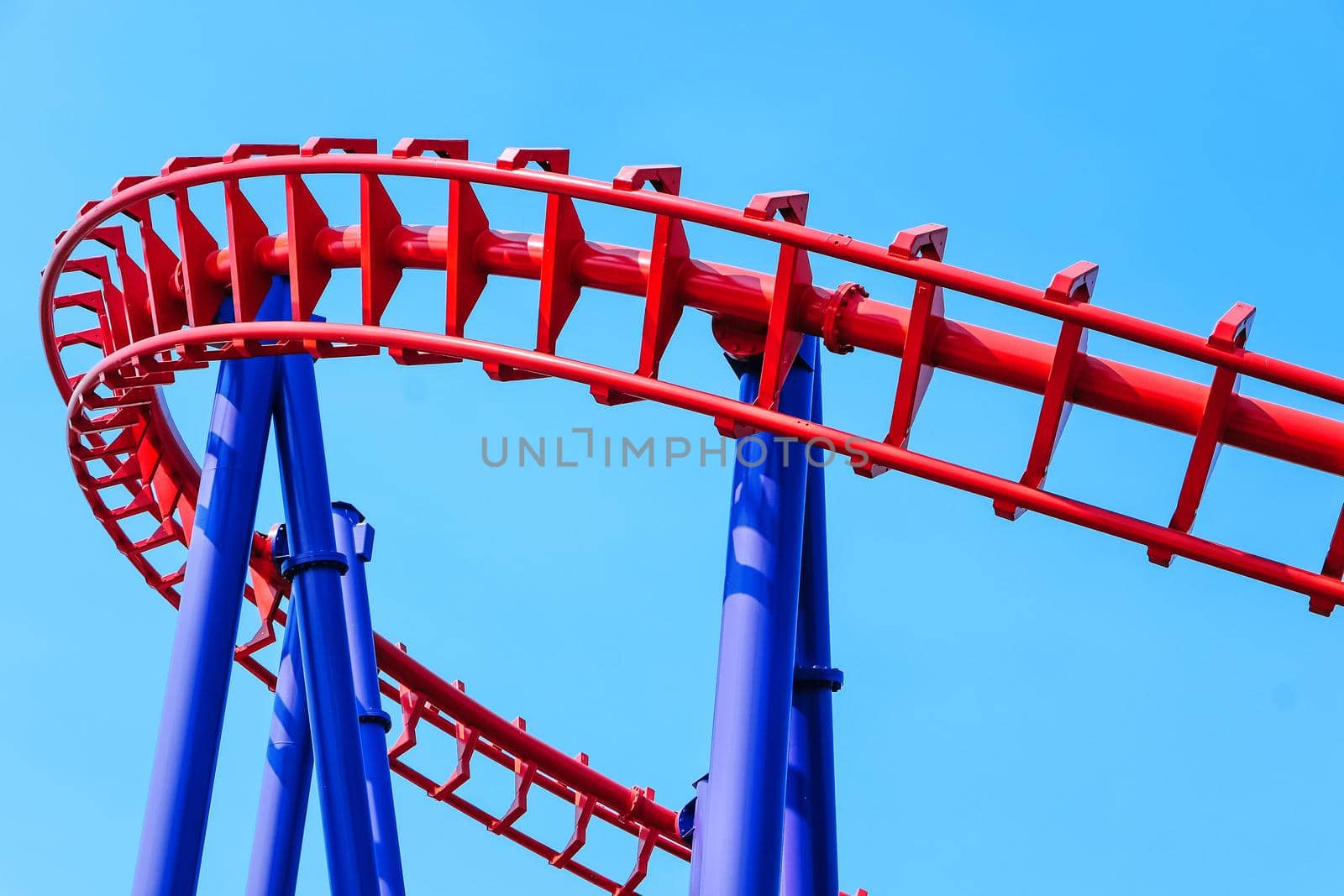 close-up image of a rollercoaster track and the blue sky