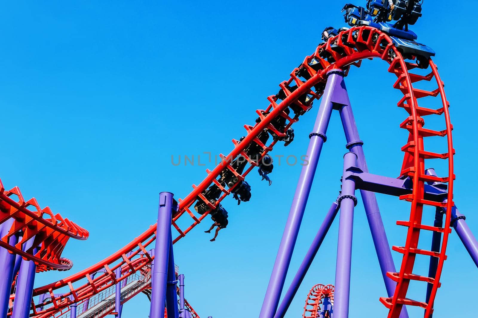close-up image of a rollercoaster track and the blue sky