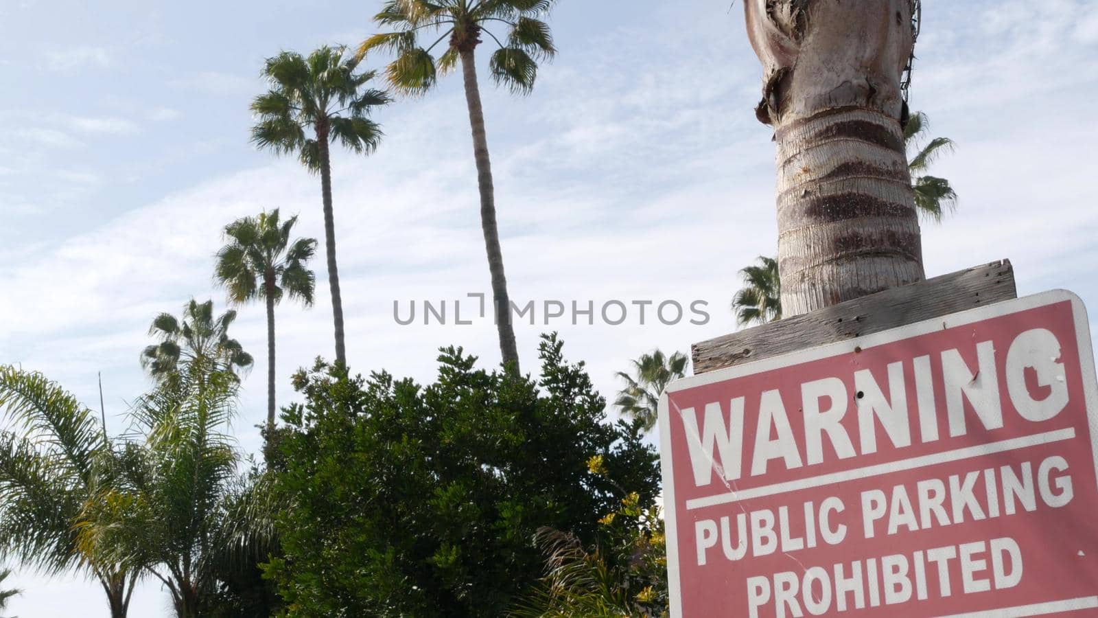 Parking lot sign as symbol of traffic difficulties and transportation issues in busy urban areas of USA. Public paid parking zone in downtown of San Diego, California. Limited space for cars in city.