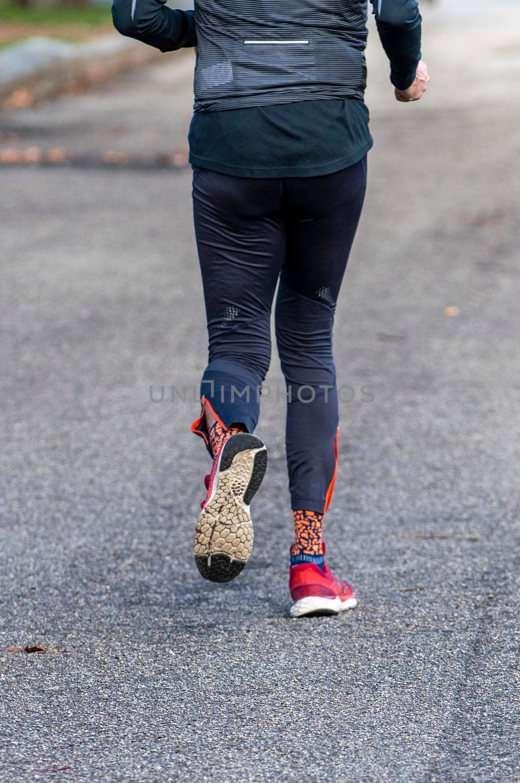 particular of woman running in the park early in the morning