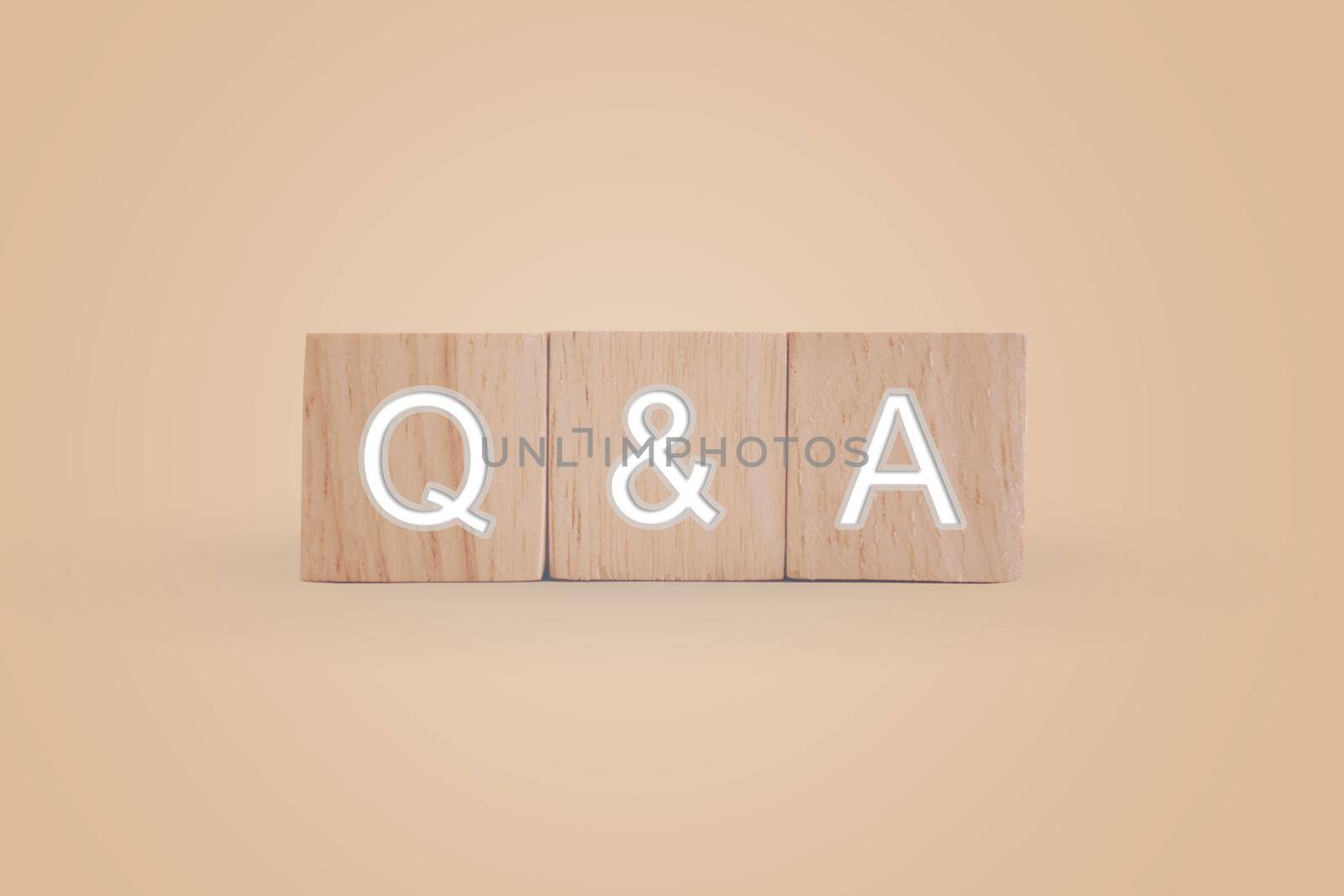 Q and A alphabet on wooden cube in hand hold with background. Question and answer meaning. by Suwant