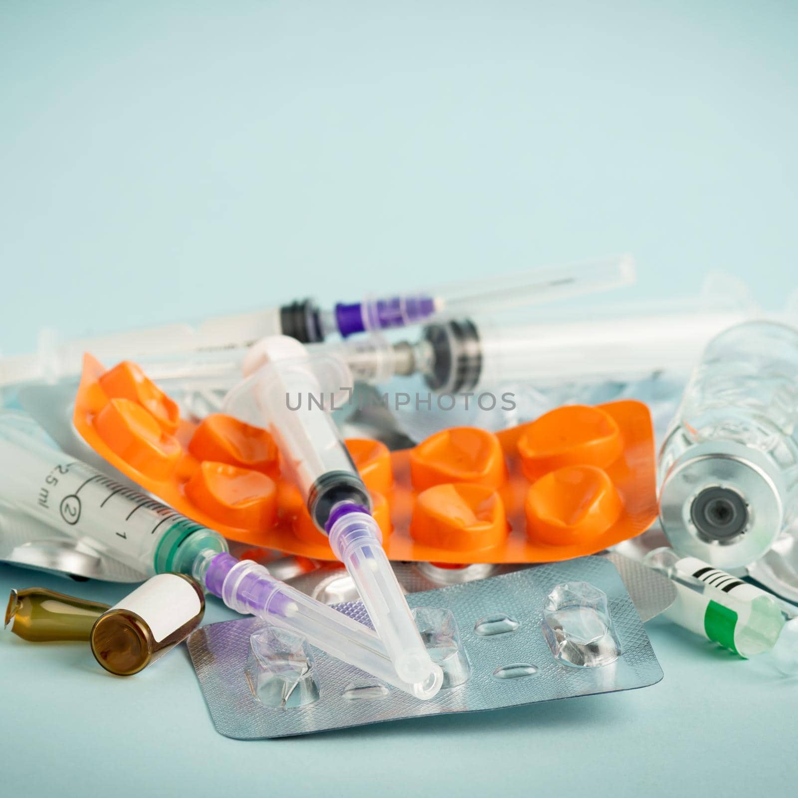 Used syringes and empty medicine containers close-up. Healthcare abstract. The problem of recycling plastic packaging.