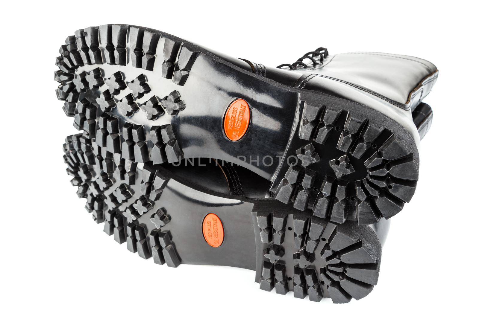 close-up wide angle view of new boots mini lugs black rubber outsole with 120 plus oil resistance grade , isolated on white background