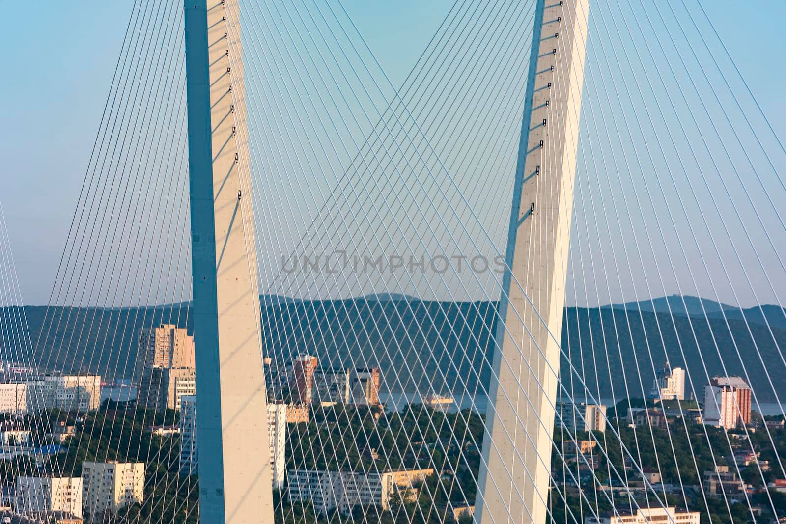 Vladivostok, Russia. Golden bridge is a landmark of the city at sunset.