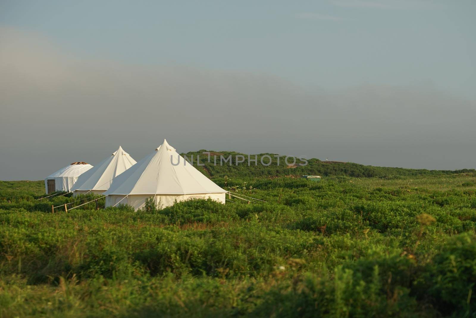 White tent on the background of the natural landscape. Travel and tourism.
