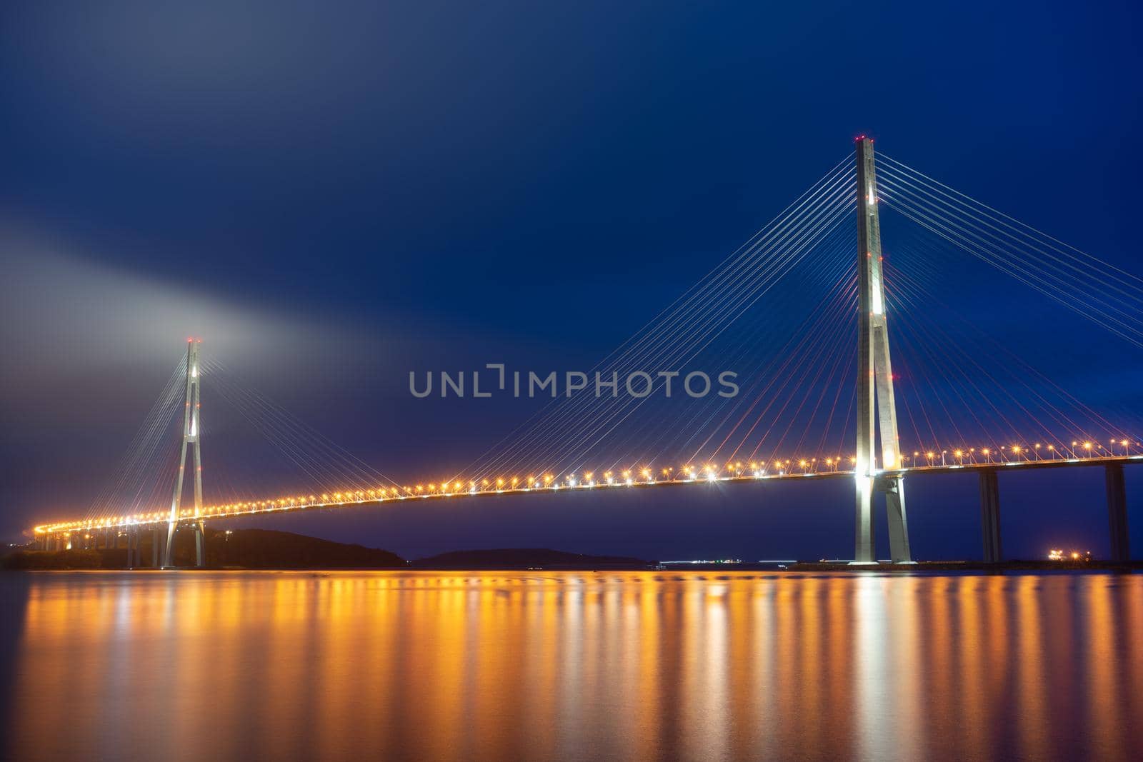 Vladivostok, Russian bridge. Night photos on a long exposure. Beautiful reflection on the surface of the sea.