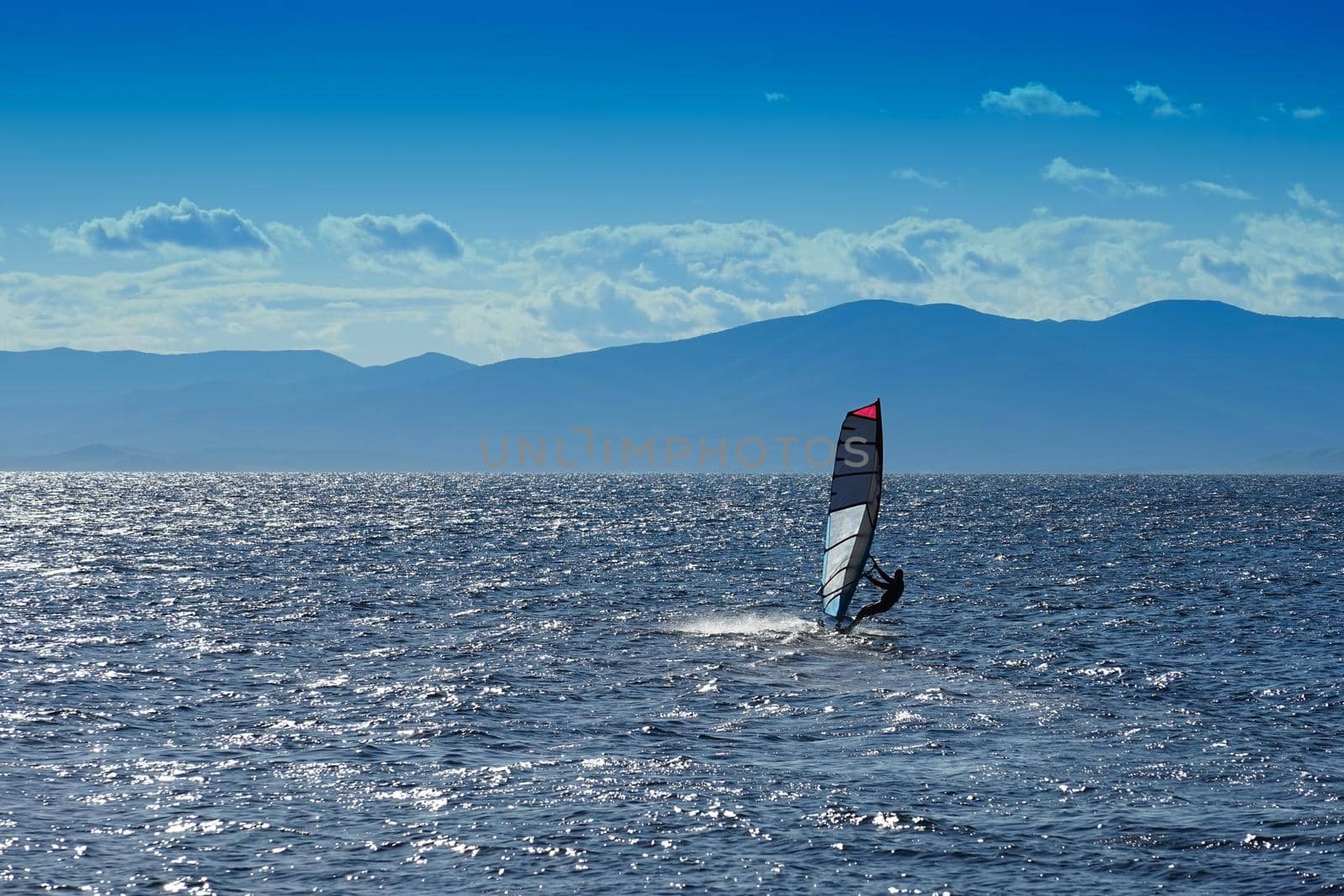 Seascape with sports boat with sail and man