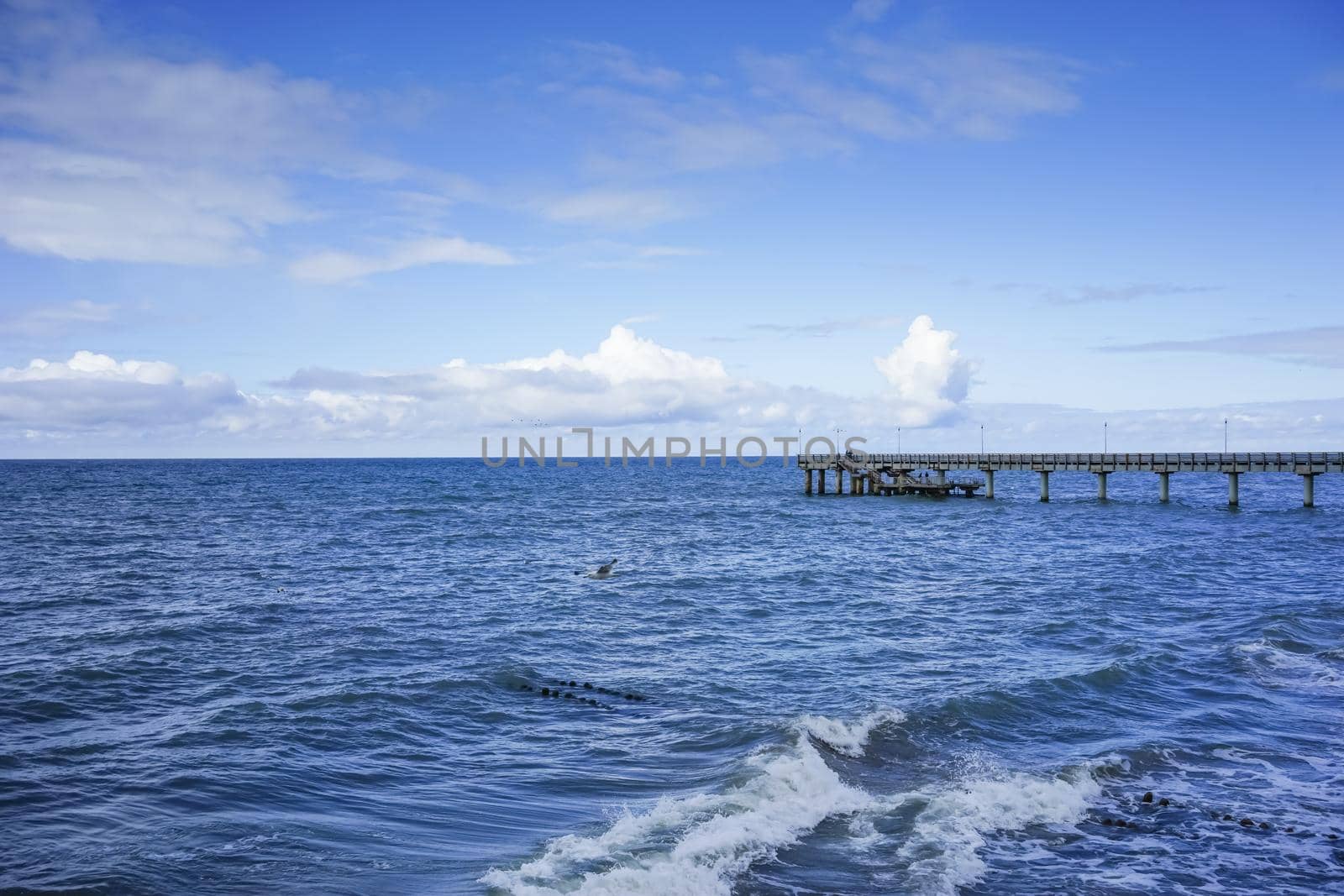 Zelenogradsk, Russia. Seascape overlooking the long pier of the resort town with walking people.