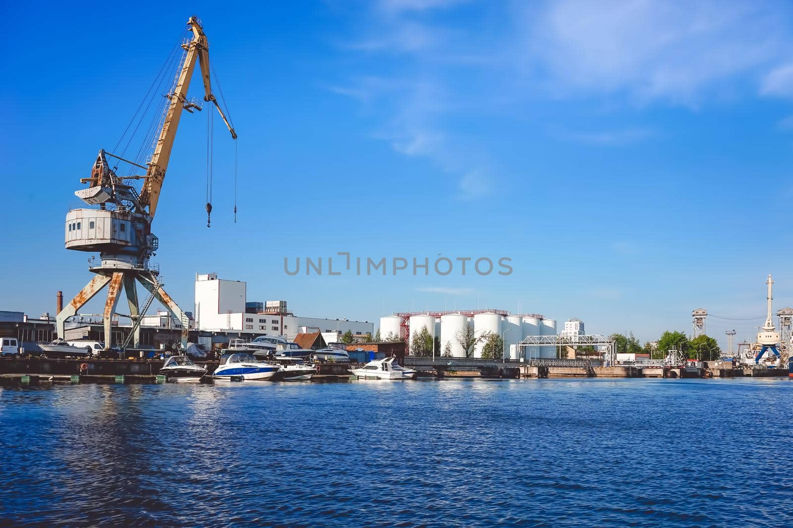 Kaliningrad , Russia. Port of a large Russian city with ships and various equipment on the background of the river.