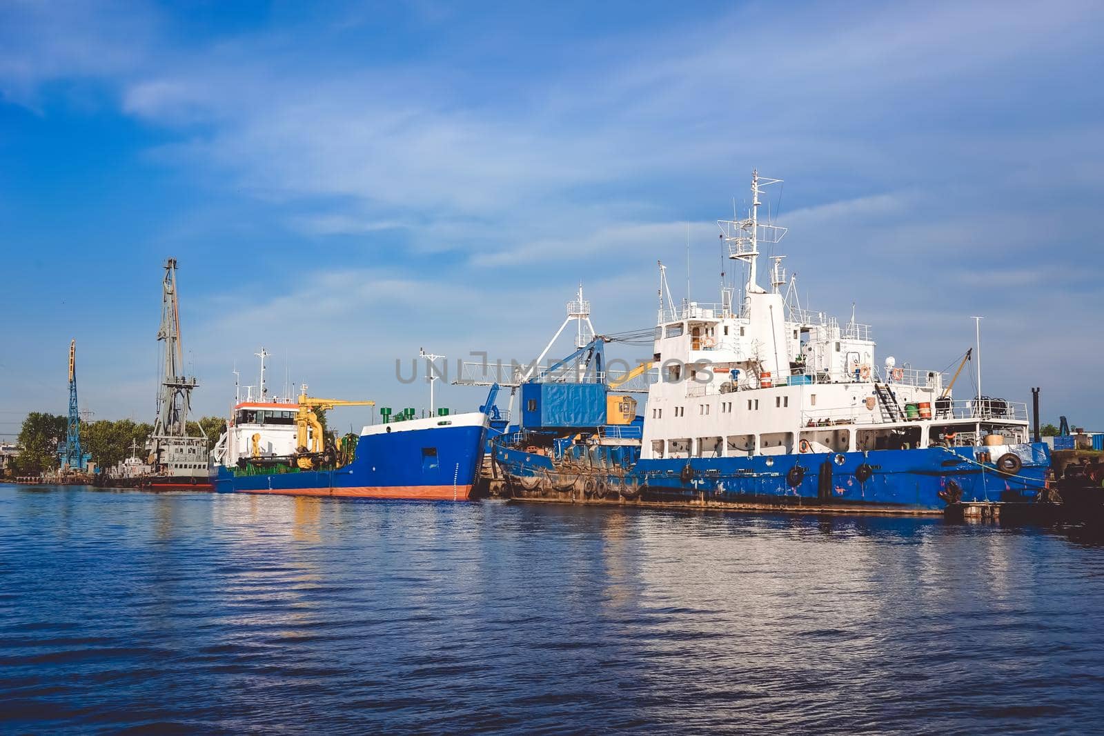 Kaliningrad , Russia. Port of a large Russian city with ships and various equipment on the background of the river.