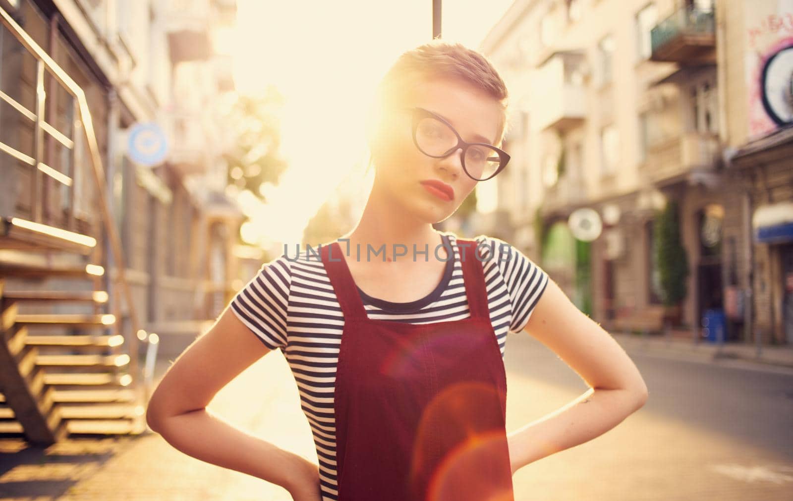 pretty woman with short hair and red lips on the street walk glass with drink by SHOTPRIME